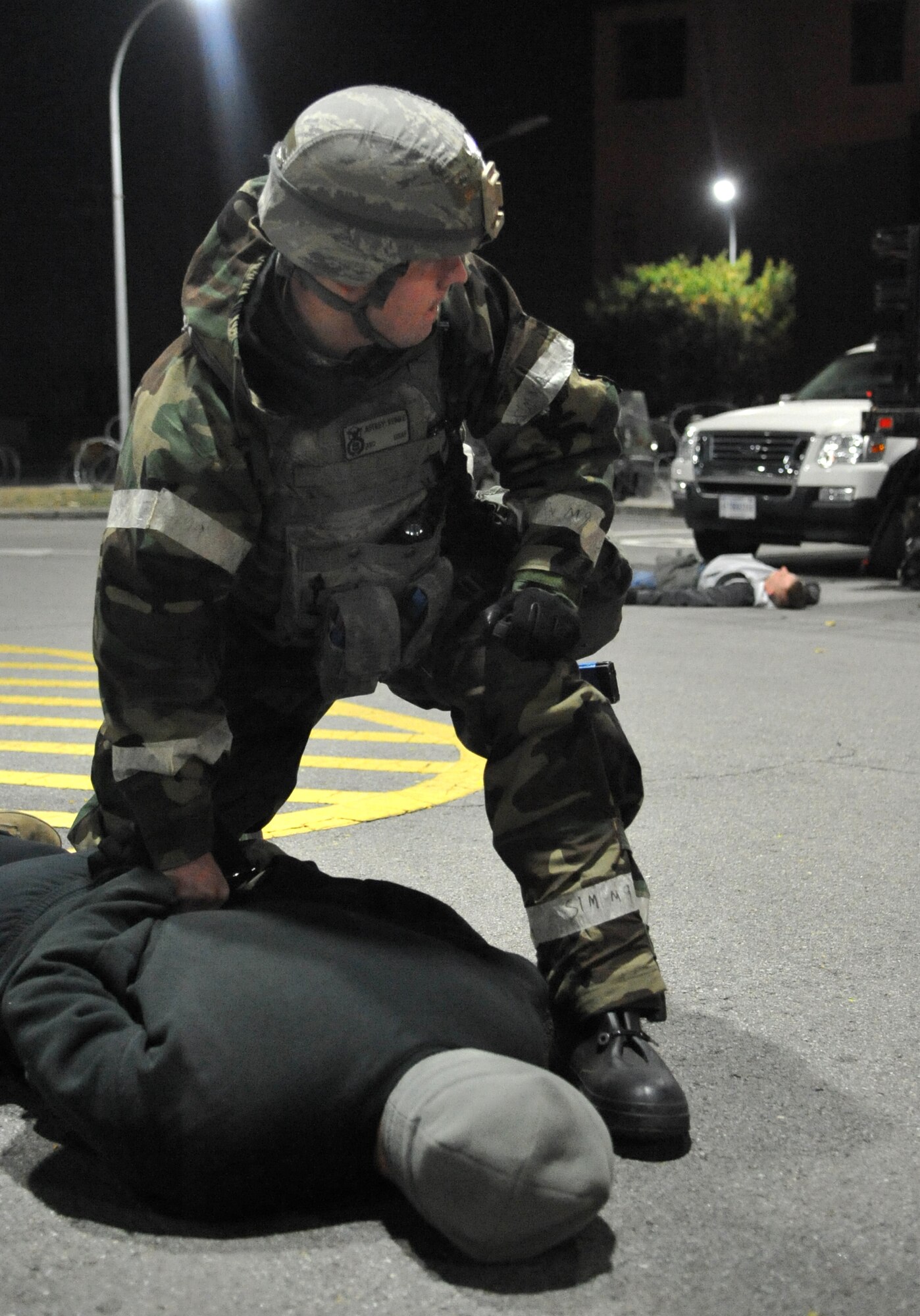 A member of the 51st Security Forces Squadron restrains a role player acting as an opposition forces member during Operational Readiness Exercise Beverly Bulldog 14-01 at Osan Air Base, Republic of Korea, Nov. 20, 2013. Opposition forces personnel staged a simulated attack outside Bldg. 1097 to provoke defenders to actively defend the 51st Fighter Wing Headquarters. (U.S. Air Force photo/Airman 1st Class Ashley J. Thum)