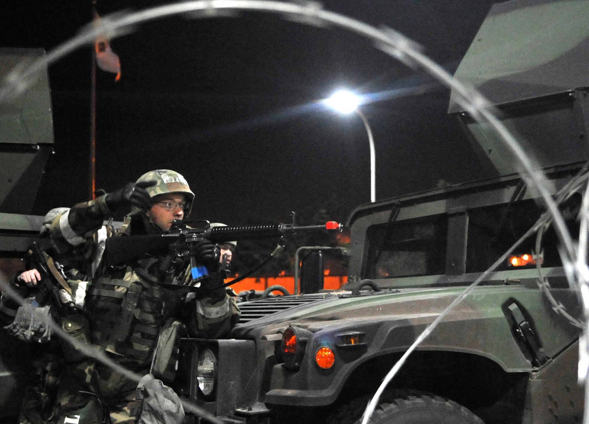 A 51st Security Forces Squadron Airman points out simulated approaching opposition forces during Operational Readiness Exercise Beverly Bulldog 14-01 at Osan Air Base, Republic of Korea, Nov. 20, 2013. Airmen engaged five role players acting as enemy attackers in one of the many battle scenarios outside Bldg. 1097. (U.S. Air Force photo/Airman 1st Class Ashley J. Thum)