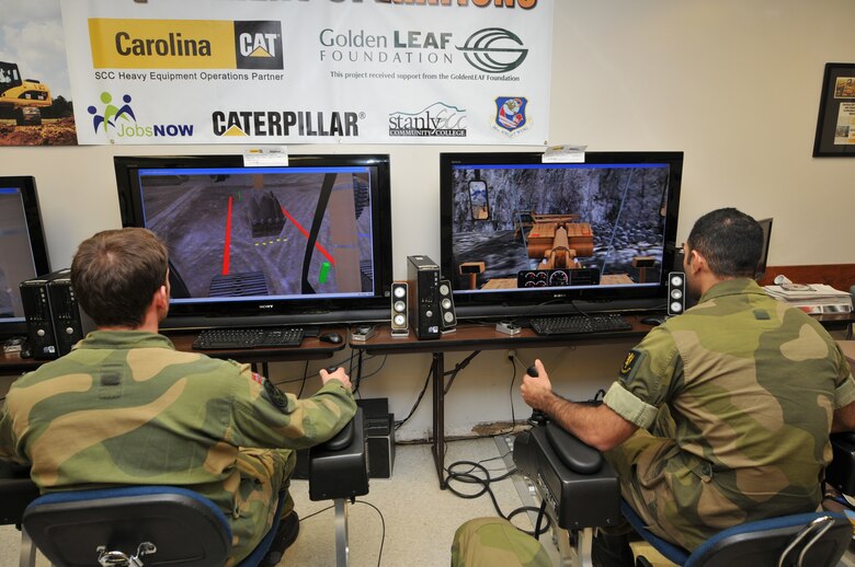 Norwegian military engineer cadets from Krigskolen Academy, Norway got a chance to cross-train with the North Carolina Air National Guard, 145th Civil Engineer Squadron by utilizing the Heavy Equipment Program on simulators at Stanly County Community College in Albemarle, N.C., October 22, 2013.  During this two week exercise held at the 145th CES Regional Training Site in New London, N.C., airmen worked in collaboration with the Norwegian Army and Air Force cadets in support of Operation Impeccable Glove.  (Air National Guard photo by Master Sgt. Patricia F. Moran/Released)