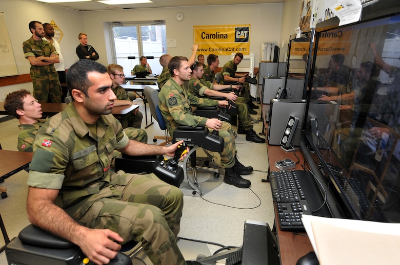 Norwegian military engineer cadets from Krigskolen Academy, Norway got a chance to cross-train with the North Carolina Air National Guard, 145th Civil Engineer Squadron by utilizing the Heavy Equipment Program on simulators at Stanly County Community College in Albemarle, N.C., October 22, 2013.  During this two week exercise held at the 145th CES Regional Training Site in New London, N.C., airmen worked in collaboration with the Norwegian Army and Air Force cadets in support of Operation Impeccable Glove.  (Air National Guard photo by Master Sgt. Patricia F. Moran/Released)