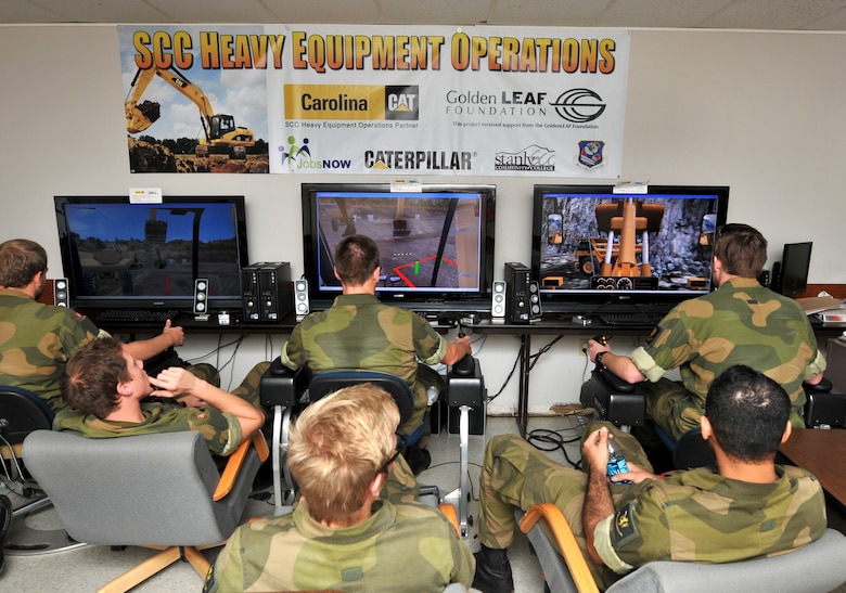 Norwegian military engineer cadets from Krigskolen Academy, Norway got a chance to cross-train with the North Carolina Air National Guard, 145th Civil Engineer Squadron by utilizing the Heavy Equipment Program on simulators at Stanly County Community College in Albemarle, N.C., October 22, 2013.  During this two week exercise held at the 145th CES Regional Training Site in New London, N.C., airmen worked in collaboration with the Norwegian Army and Air Force cadets in support of Operation Impeccable Glove.  (Air National Guard photo by Master Sgt. Patricia F. Moran/Released)