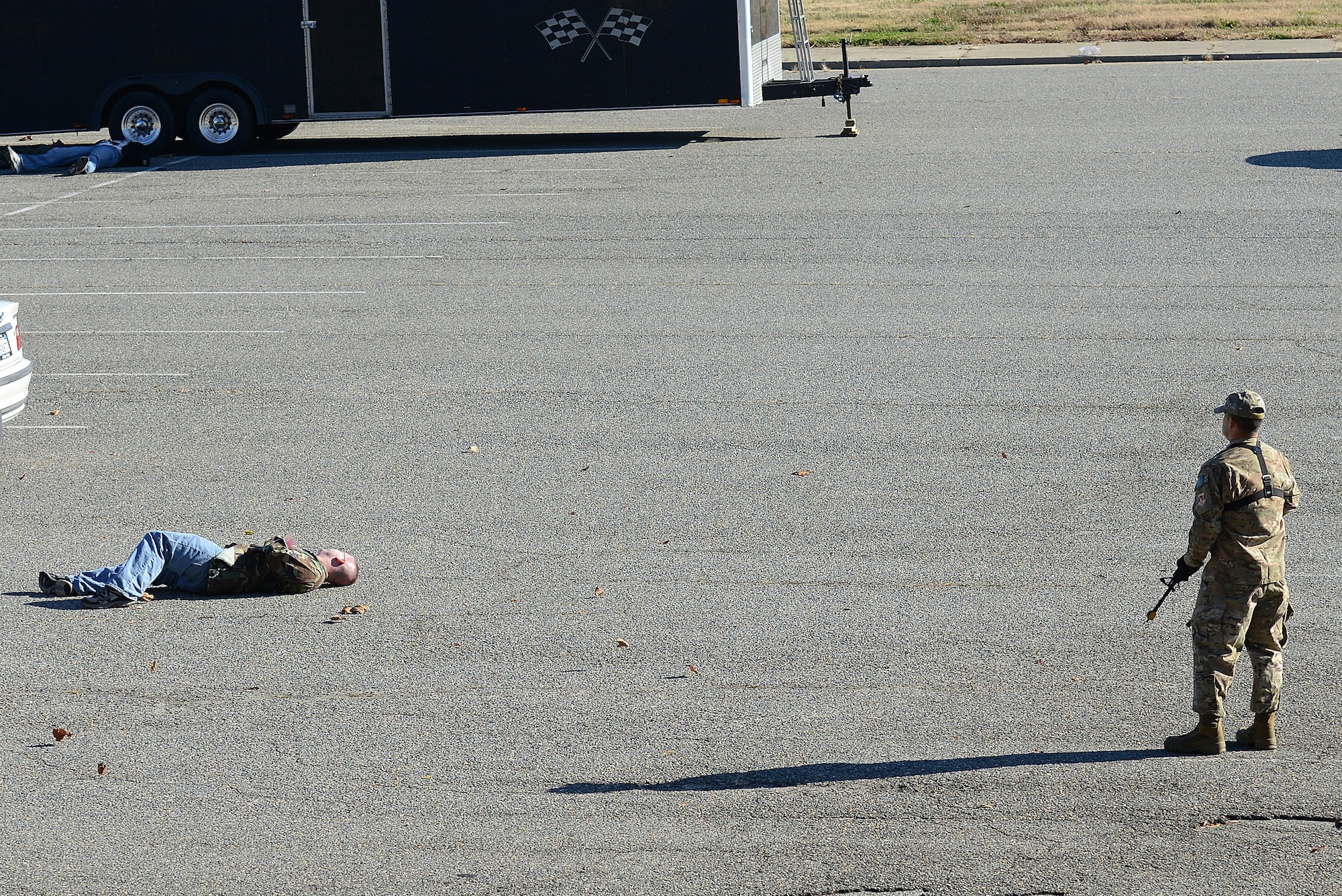 U.S. Air Force Master Sgt. Scott Wagonblott, 633rd Communications Squadron information assurance manager, approaches a simulated gunshot victim during an active-shooter exercise at Langley Air Force Base, Va. Nov. 19, 2013. 
The simulation featured Wagonblott opening fire on unsuspecting victims during a failed vehicle sale at the base dormitory parking lots. (U.S. Air Force photo by Airman 1st Class Kimberly Nagle/Released)
