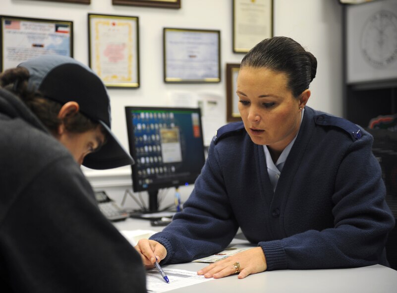 U.S. Air Force Staff Sgt. Regina Cooper, 336th Recruiting Squadron enlisted accessions recruiter, explains Air Force pre-requisites  to a Delayed Entry Program recruit  in Valdosta, Ga., Nov. 13, 2013. . Cooper ensures all necessary paperwork is signed and completed before the recruit is sent to the Military Entrance Processing Station to undergo the enlistment process. (U.S. Air Force photo by Senior Airman Olivia Bumpers/Released)