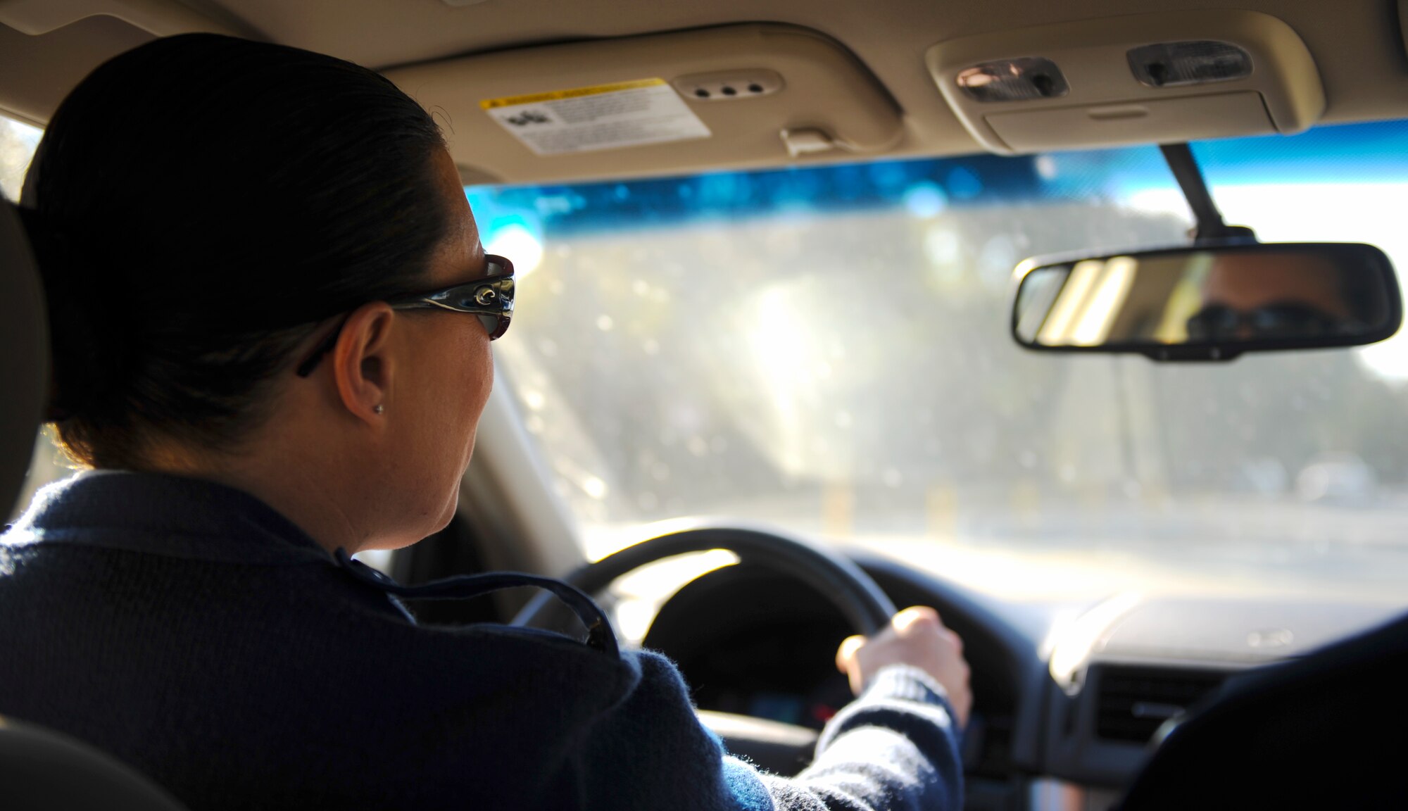 U.S. Air Force Staff Sgt. Regina Cooper, 336th Recruiting Squadron enlisted accessions recruiter, drives to Lowndes High School in Valdosta, Ga., Nov. 13, 2013. Cooper visits local high schools, participates in career fairs and hosts events at parades to speak about benefits the Air Force offers. (U.S. Air Force photo by Senior Airman Olivia Bumpers/Released)