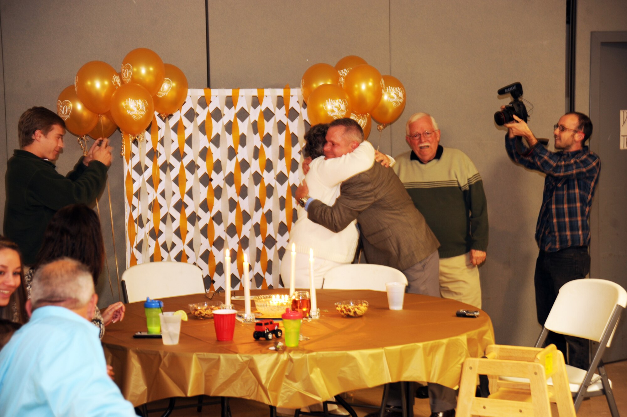 Col. Wayne Blanchette, vice chief for the Office of Military Cooperation at the U.S. Embassy in Kuwait, surprises his parents, Ray and Betty Blachette, during a surprise celebration for their 50th wedding anniversary Nov. 15, 2013. Colonel Blanchette planned the moment for three months. (U.S. Air Force photo/Staff Sgt. Clinton Atkins)