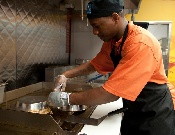 Darrel McDuffy, a Denny’s cook, grills chicken and burgers at the Exchange Denny’s Fresh Express, Nov. 19, 2013, at Nellis Air Force Base, Nev. None of the food is frozen or pre-cooked; meaning that only fresh food is served ensuring the highest quality product. (U.S. Air Force photo by Airman 1st Class Thomas Spangler)