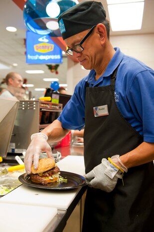 Rodel Samson, a Denny’s cook, prepares a cheeseburger at the Exchange Denny’s Fresh Express Nov. 19, 2013, at Nellis Air Force Base, Nev. All of the food prepared at Denny’s is fresh and is prepared as soon as the customer orders. The Denny’s Fresh Express is the newest addition to the Exchange food court and is the first Denny’s in the entire Army and Air Force Exchange Service. (U.S. Air Force photo by Airman 1st Class Thomas Spangler)