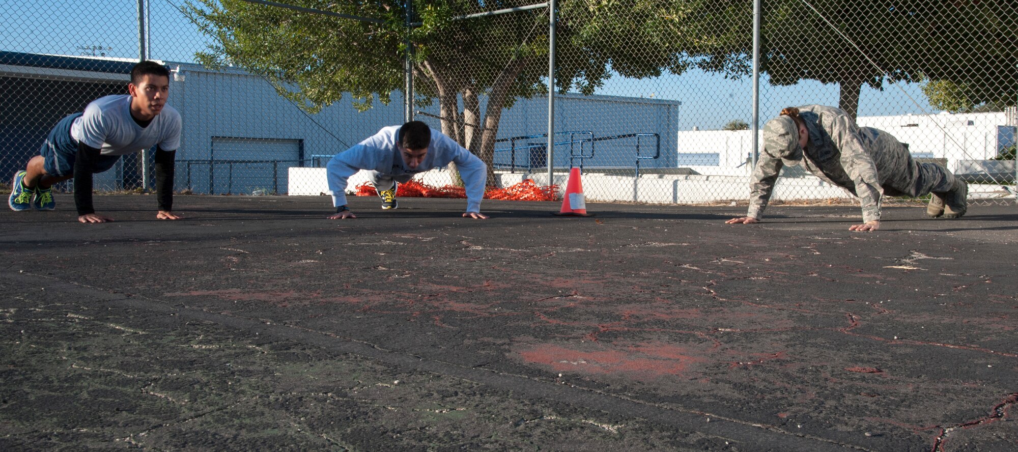 First Lt. Laura Watson, right, Laughlin Company Grade Officers' Council vice president, leads her Air Force Junior ROTC group in push-ups at Del Rio High School, Texas, Nov. 15, 2013. The interaction with the students and CGOs helps the students learn more about the Air Force. (U.S. Air Force photo/2nd Lt. William M. Tyrrell)  