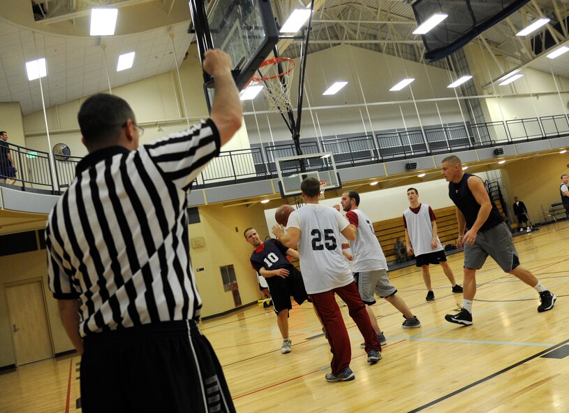 A foul is called during an intramural basketball game in the fitness center at Fairchild Air Force Base, Wash., Nov. 14, 2013. There are 10 teams competing against each other for the championship. (U.S. Air Force photo by Airman 1st Class Ryan Zeski/Released)