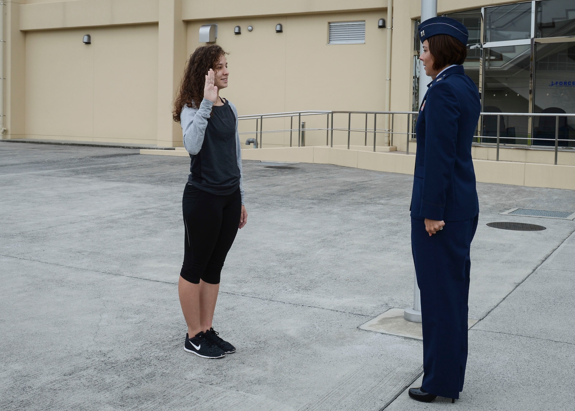Capt. Karina Glover administers the oath of enlistment to her daughter, Sydney Glover, just prior to her departure for Basic Military Training Oct. 15. (U.S. Air Force photo/Airman 1st Class Meagan Schutter)