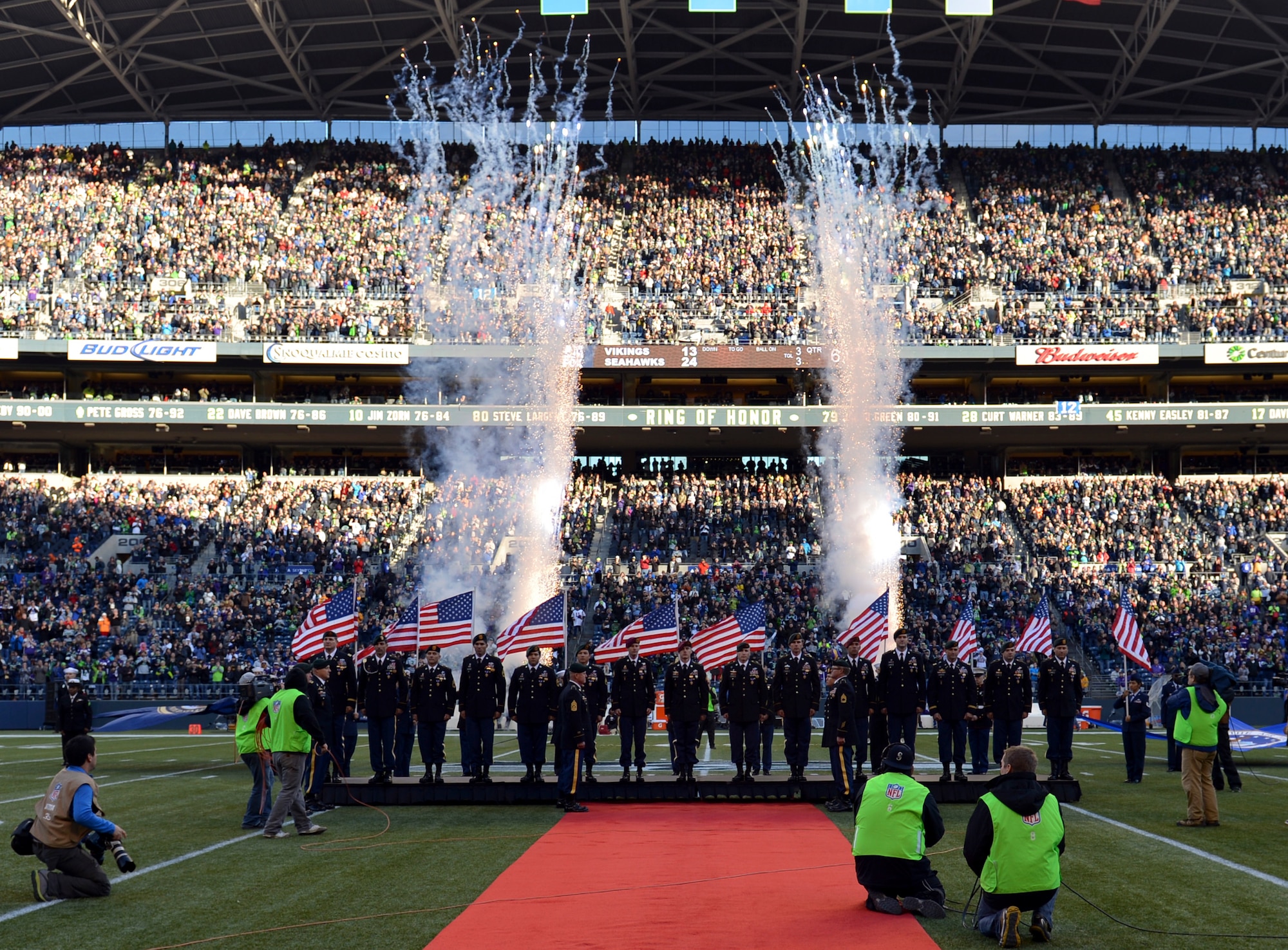 Fireworks ignite, American flags wave and the crowd stands to cheer as 15 Soldiers receive Purple Heart medals during a halftime ceremony at the Seattle Seahawks vs. Minnesota Viking football game at Safeco Field, Jan. 17, 2013 in Seattle, Wash. More than 150 military members volunteered to participate in the Seattle Seahawks “Salute to Service” pregame and halftime ceremonies. (U.S. Air Force photo/Staff Sgt. Jason Truskowski)