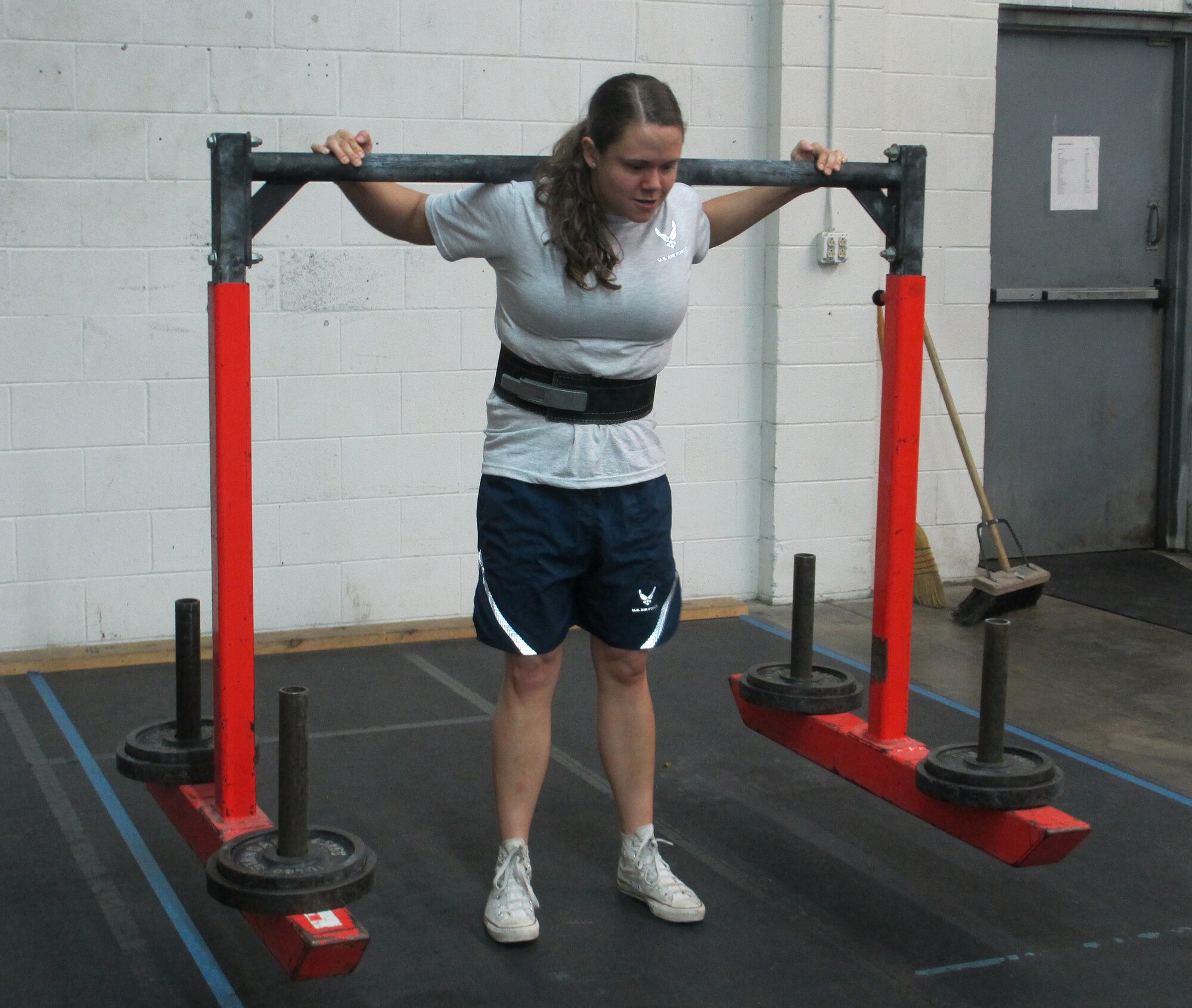 Staff Sgt. Stephanie Marin, 317th Recruiting Squadron recruiter, carries this 300-pound yoke for 60 feet at a gym in Richmond, Va. (U.S. Air Force photo)