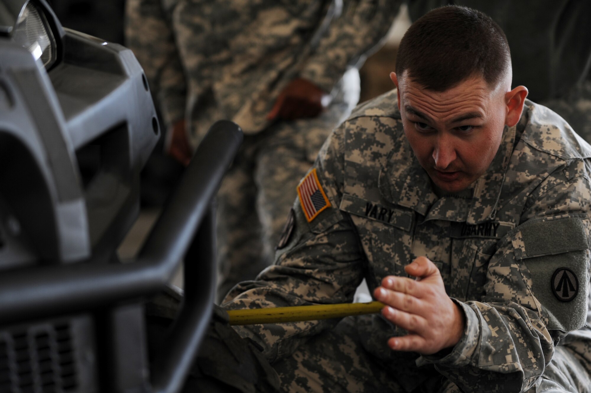 A U.S. Army Soldier with the 689th Rapid Port Opening Element measures an all-terrain vehicle during a joint training exercise inside the Small Air Terminal at Langley Air Force Base, Va., Nov. 19, 2013. The exercise ensured the 689th RPOE could quickly process and load equipment onto an aircraft and respond to a crisis or disaster anywhere in the world. (U.S. Air Force photo by Staff Sgt. Jarad A. Denton/Released)