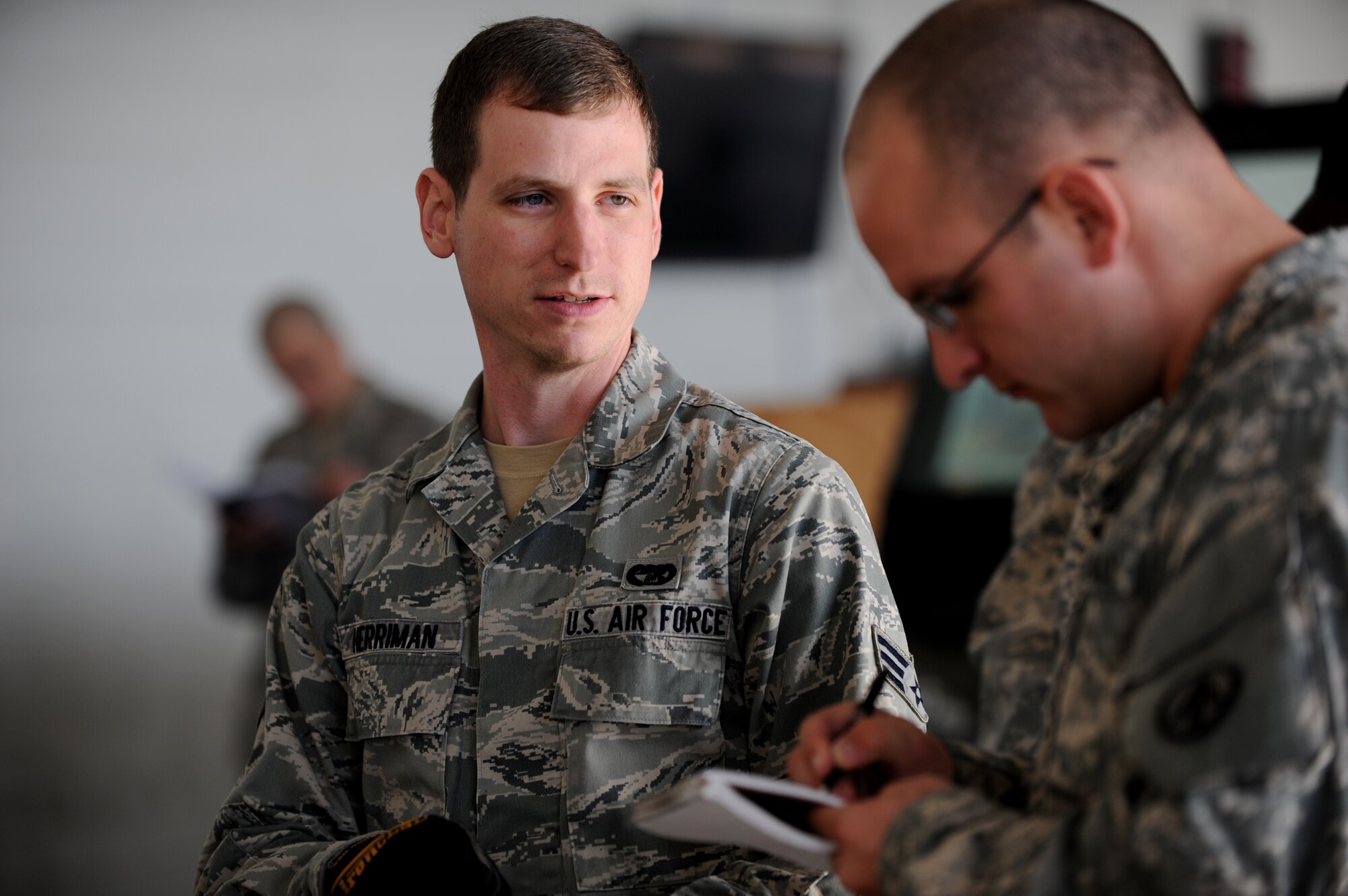 U.S. Air Force Senior Airman Sean Herriman, 633rd Logistics Readiness Squadron, instructs a U.S. Army Soldier from the 689th Rapid Port Opening Element on proper cargo inspection techniques during a joint training exercise inside the Small Air Terminal at Langley Air Force Base, Va., Nov. 19, 2013. The exercise tested the ability of the 689th RPOE to process cargo and be airborne to anywhere in the world within 12 hours after receiving notification of a crisis or disaster. (U.S. Air Force photo by Staff Sgt. Jarad A. Denton/Released)