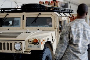 U.S. Army Soldiers from the 689th Rapid Port Opening Element position a Humvee atop a weighing platform inside the Small Air Terminal at Langley Air Force Base, Va., Nov. 19, 2013. The Humvee was weighed and inspected as part of a joint training exercise between Langley Airmen and Fort Eustis Soldiers, designed to prepare the Army element for rapid deployment and crisis response. (U.S. Air Force photo by Staff Sgt. Jarad A. Denton/Released)