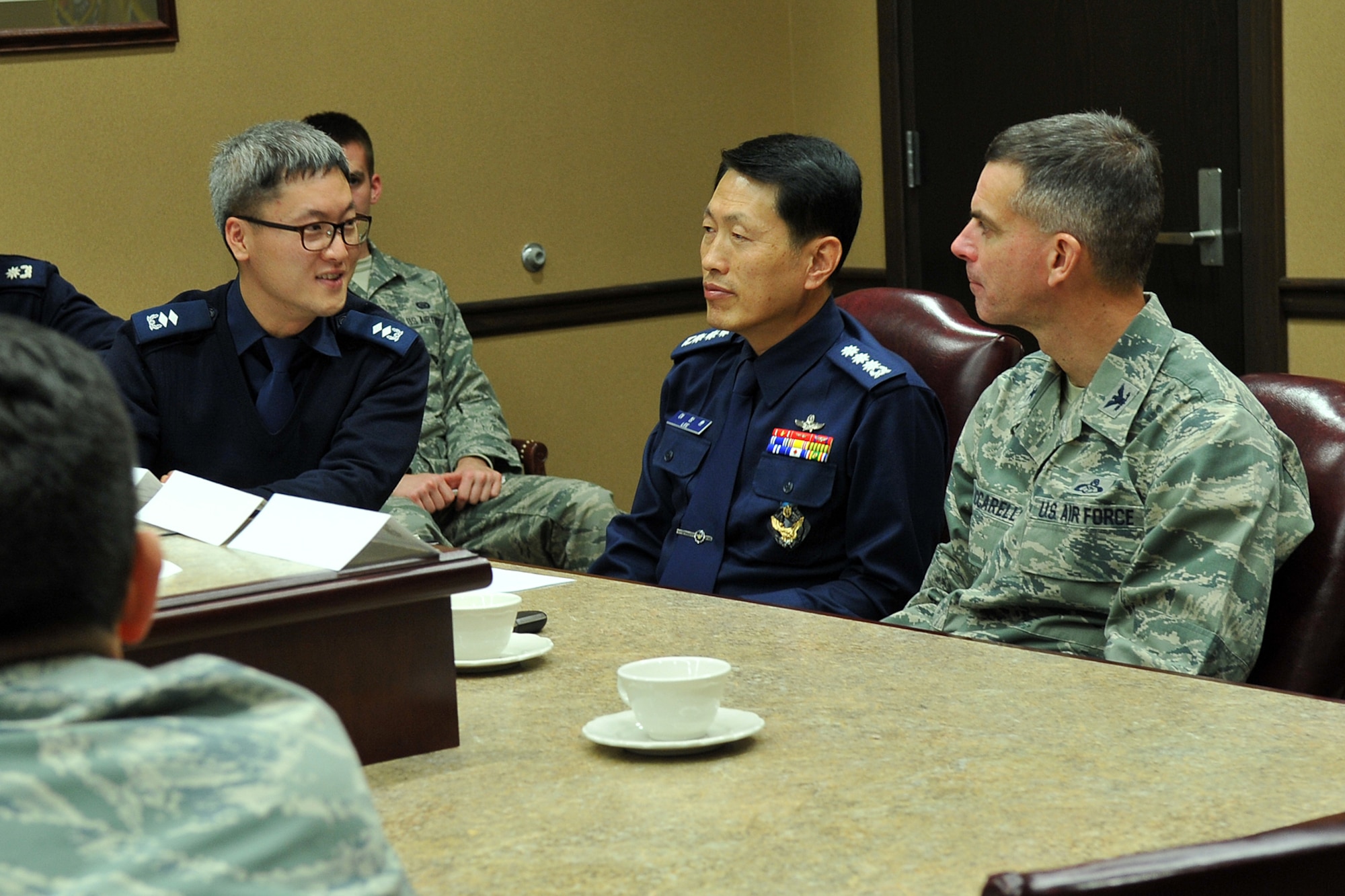 OFFUTT AIR FORCE BASE, Neb. -- Republic of Korea Air Force Col. Chang Hoon Lee, ROKAF Weather Wing commander, listens to ROKAF Maj. Jaeik Song as he translates words from U.S. Air Force Col. Louis Zuccarello, Air Force Weather Agency commander, during a visit to the AFWA headquarters on Nov. 12. The ROKAF colonel toured the headquarters facility, received multiples briefings and worked with AFWA’s leadership on identifying areas for cooperation and exchange that would build on the existing strong relationship between the two longtime allies. (Photo by Charles Haymond)