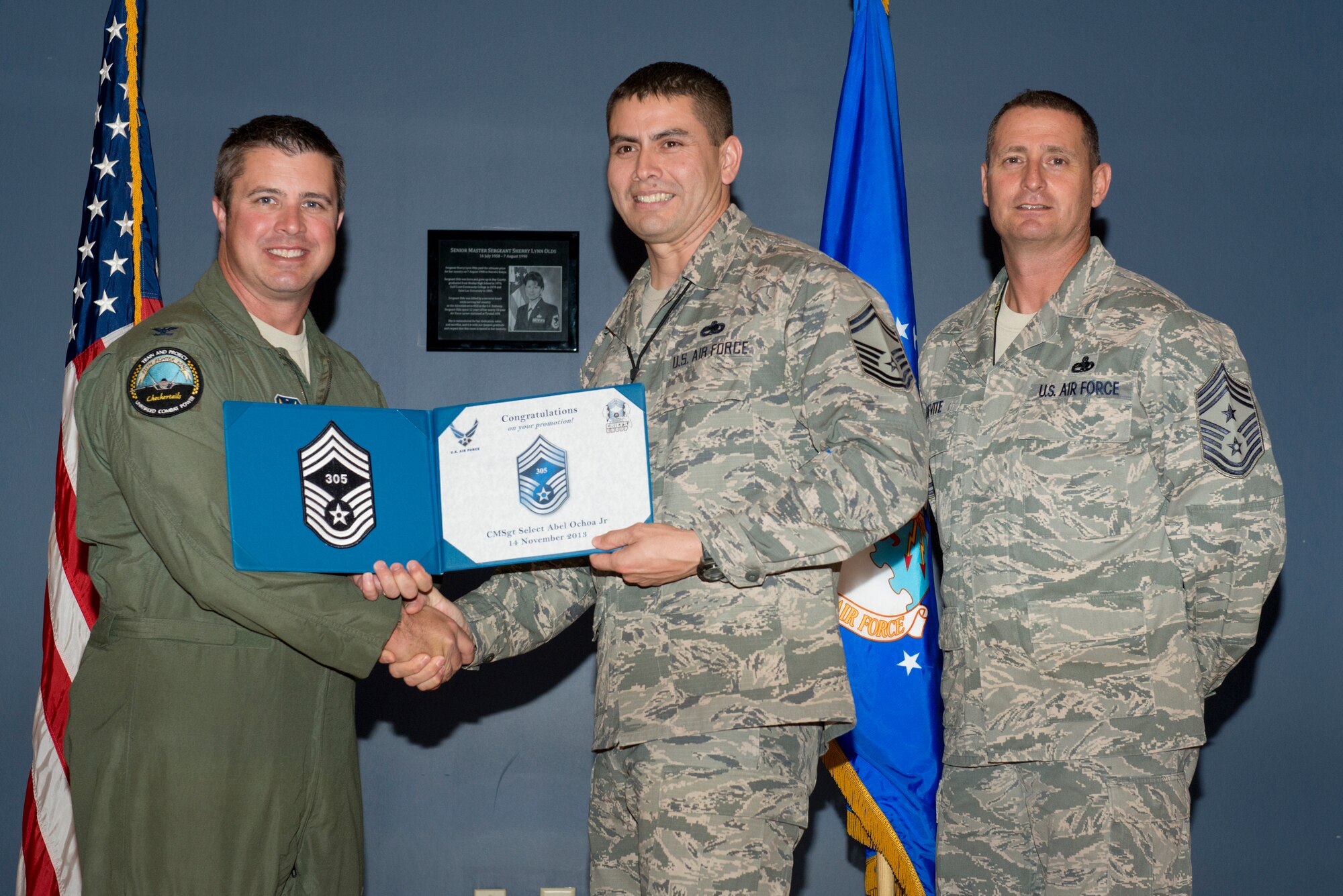 Senior Master Sgt. Abel Ochoa Jr. receives his Chief Master Sgt. selection certificate from Col. David Graff, 325th Fighter Wing commander, and Chief Master Sgt. Raymond DeVite, 325th Fighter Wing Command Chief during a Chief Master Sgt. selection ceremony Nov. 14. Chief Master Sgt. select Ochoa is the Air Forces Northern Superintendent of International Military Affairs, Plans, Policy & International Military Affairs Directorate. 