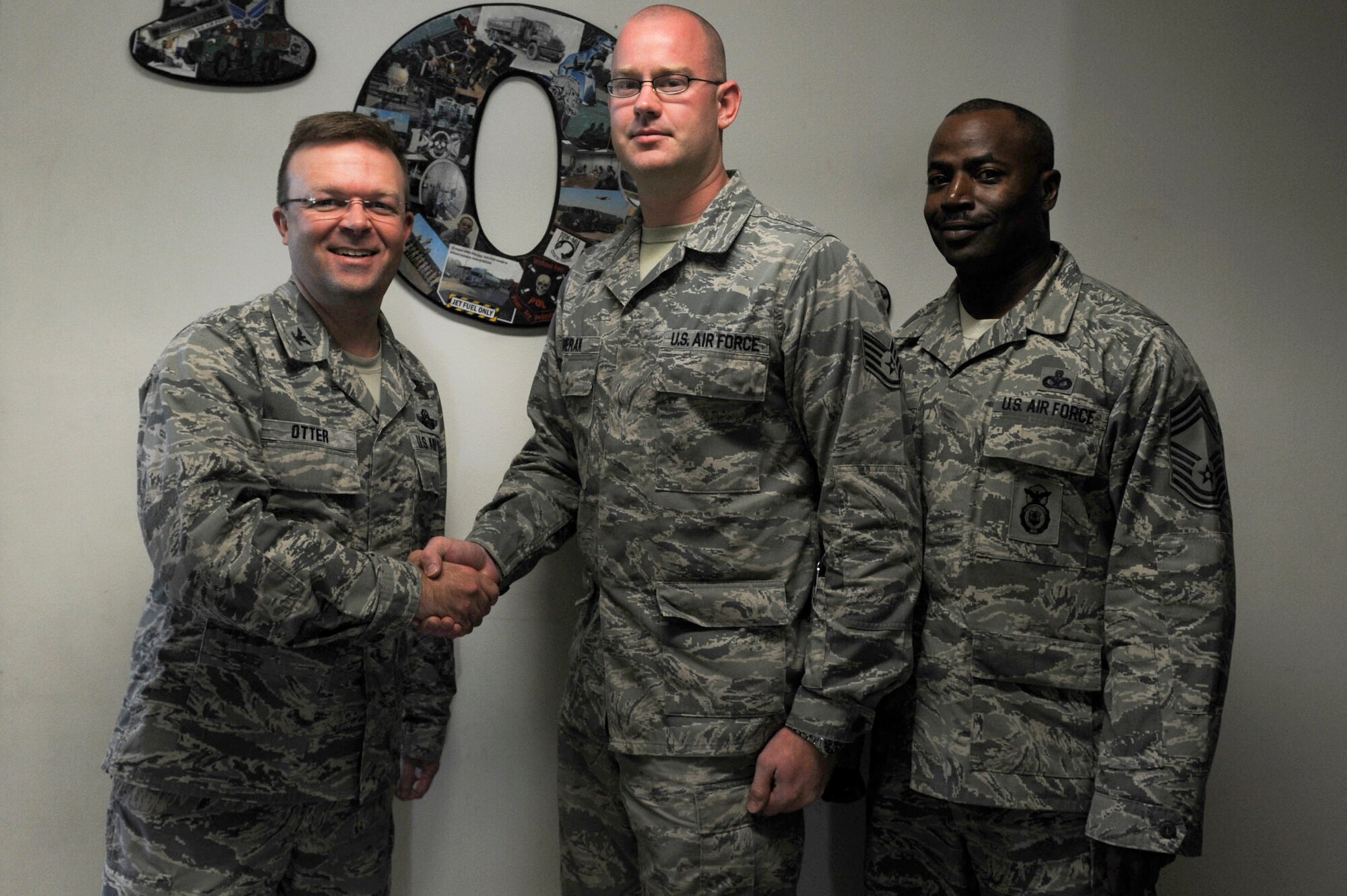 Staff Sgt. Matthew Gierak, 19th Logistics Readiness Squadron noncommissioned officer in charge of fuels environmental safety office, is congratulated by Col. William Otter, 19th Airlift Wing vice commander, and Chief Master Sgt. Anthony Erskine, 19th Security Forces Squadron security forces manager, for his selection as Combat Airlifter of the Week Nov. 18, 2013, at Little Rock Air Force Base, Ark. Gierak, a Livonia, Mich., native, engineered & implemented a flight lockout/tag out program ensuring 31 hazardous assets were safely used while also ensuring no fuel contamination. (U.S. Air Force photo by Staff Sgt. Jessica Condit)