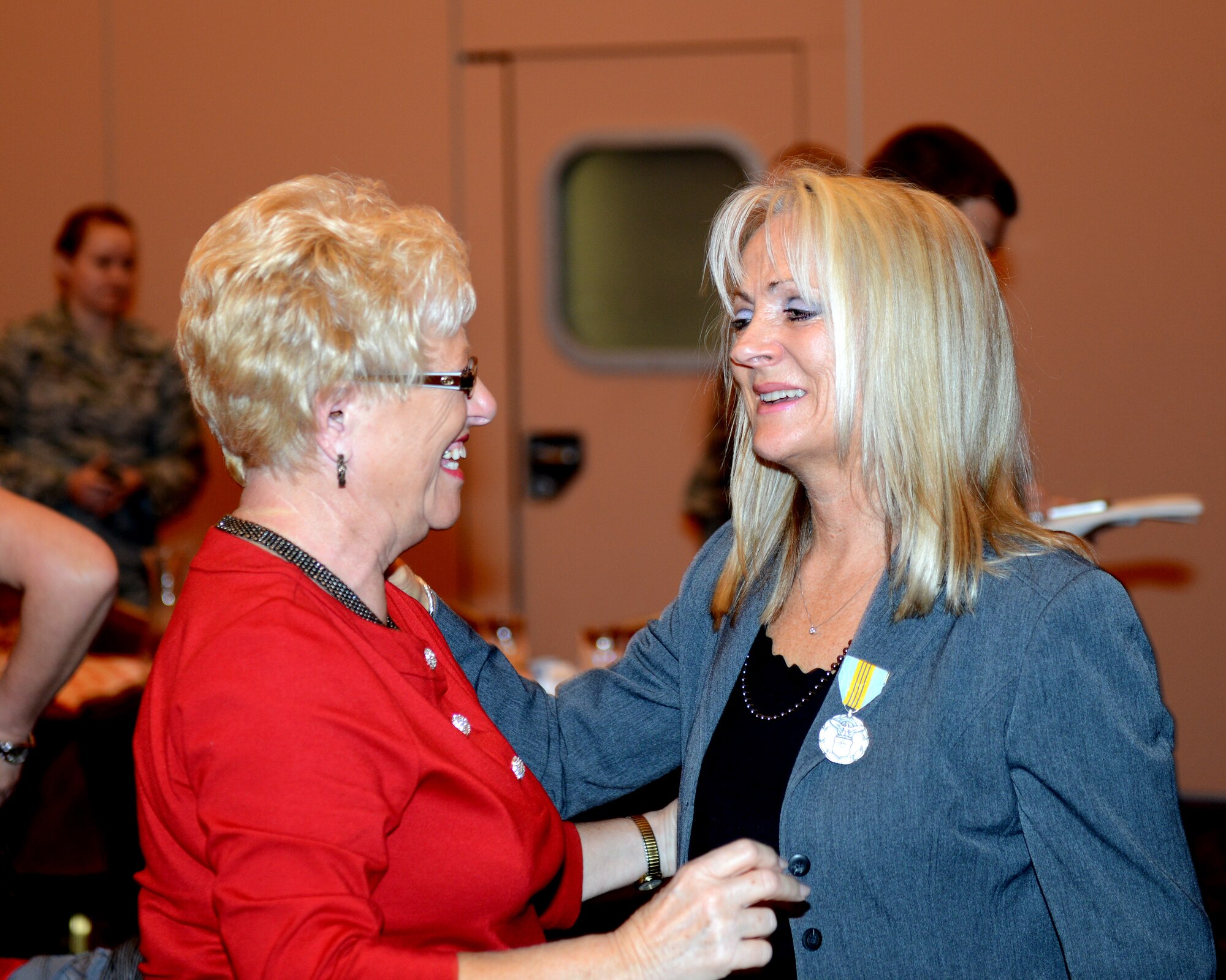 Sandra Buna, 31st Maintenance Group commander secretary, talks to her friend during her retirement ceremony, Nov. 8, 2013, at Aviano Air base, Italy. On Nov. 27, Buna is scheduled to retire after 36 years of service to the Air Force. (U.S. Air Force photo/Airman Ryan Conroy)