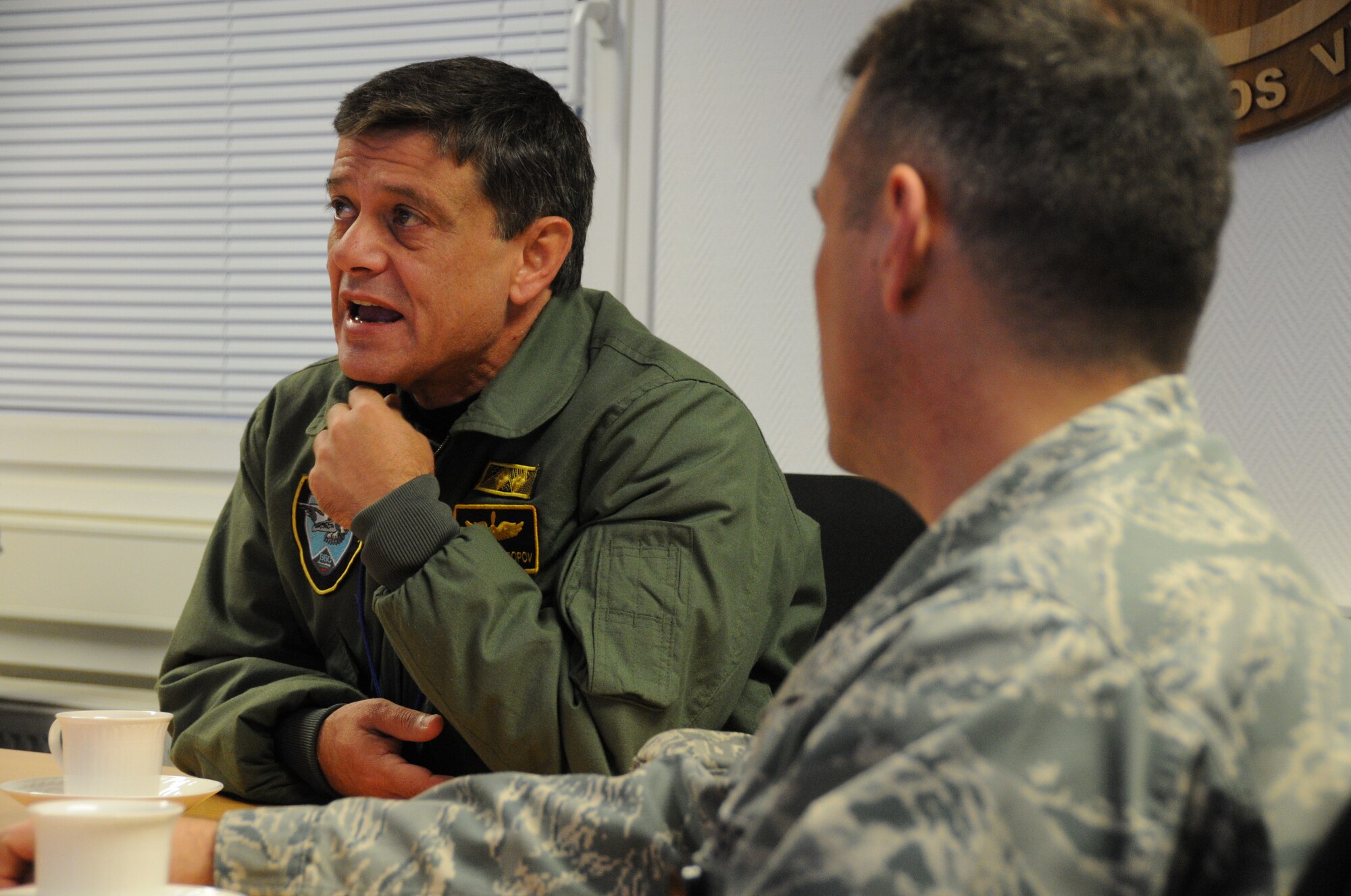 Maj. Gen. Constantin Popov, commander of the Bulgarian air force, asks a question while Col. Cloyce Adams, Warrior Preparation Center commander listens, during a European Integrated Air Missile Defense Center presentation at the WPC Nov. 19, 2013. Popov also met with Gen. Frank Gorenc, U.S. Air Forces in Europe and Air Forces Africa commander. (U.S. Air Force Photo by Tech. Sgt. James M. Hodgman)