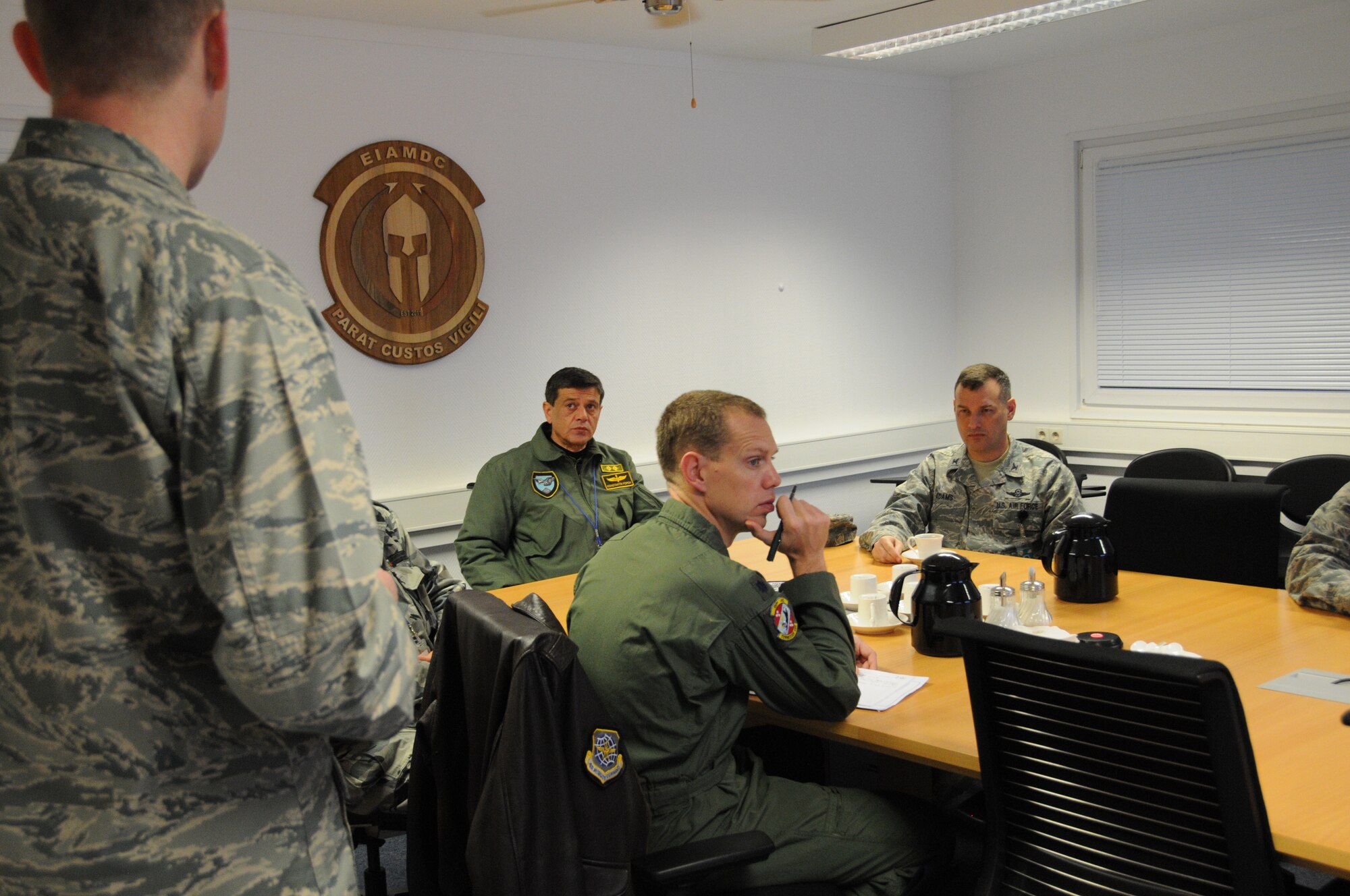 Maj. Gen. Constantin Popov, commander of the Bulgarian air force; Col. Cloyce Adams, Warrior Preparation Center commander; and Lt. Col. Andy Rowe, Bilateral Affairs officer for the U.S. Embassy in Sofia, Bulgaria, listen to a European Integrated Air Missile Defense Center presentation from Maj. Judd Jones, EIAMDC director at the WPC Nov. 19, 2013. Popov visited the WPC to learn about the ballistic missile defense mission. He also met with Gen. Frank Gorenc, U.S. Air Forces in Europe and Air Forces Africa commander. (U.S. Air Force Photo by Tech. Sgt. James M. Hodgman)
