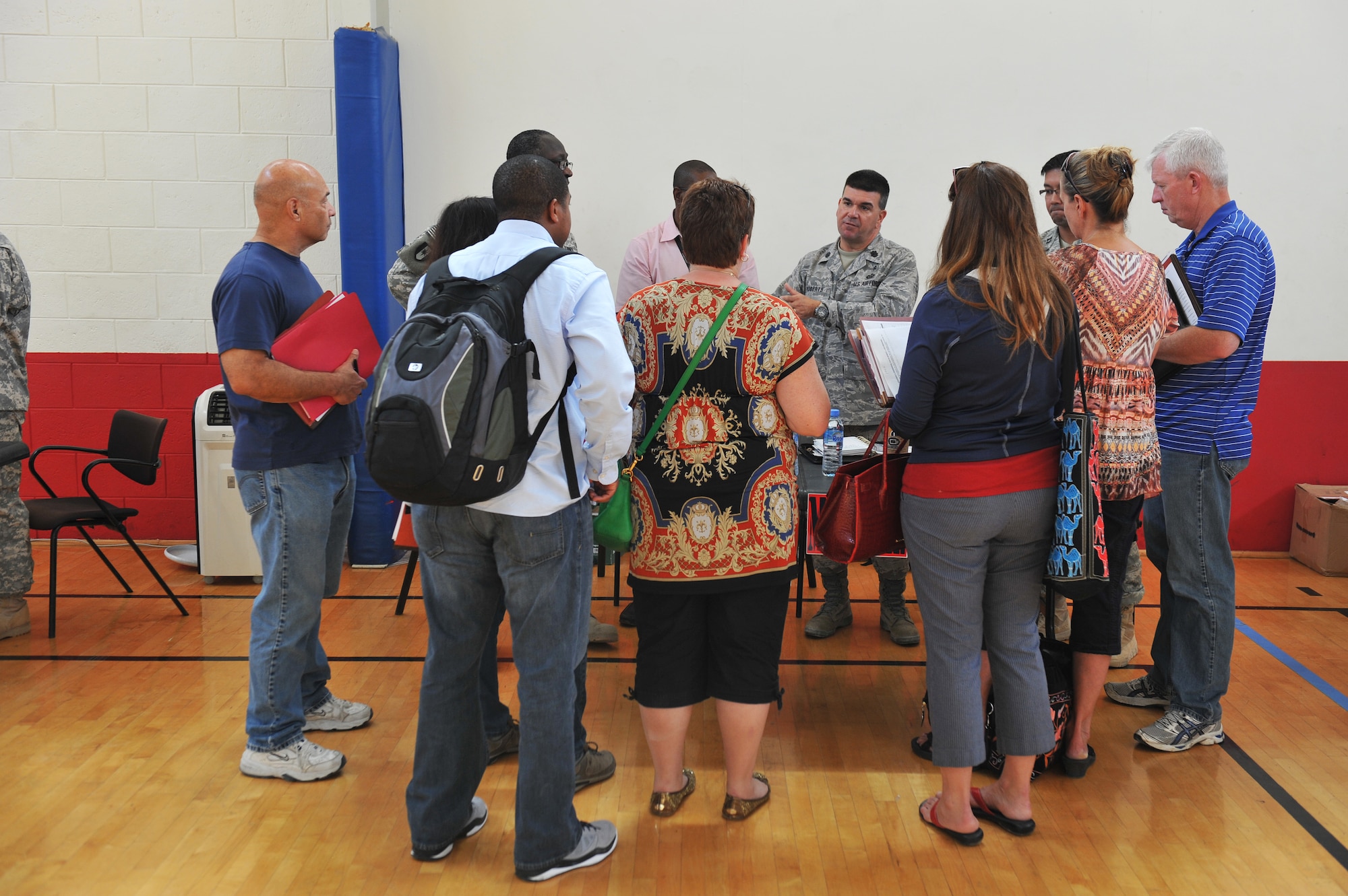 U.S. military dependents and command sponsored civilians receive a briefing during a noncombatant evacuation operations exercise at an undisclosed location in Southwest Asia, Nov. 16, 2013. The exercise allowed noncombatants to learn the evacuation process from the host nation in the event of an emergency. (U.S. Air Force photo/Master Sgt. David Miller)