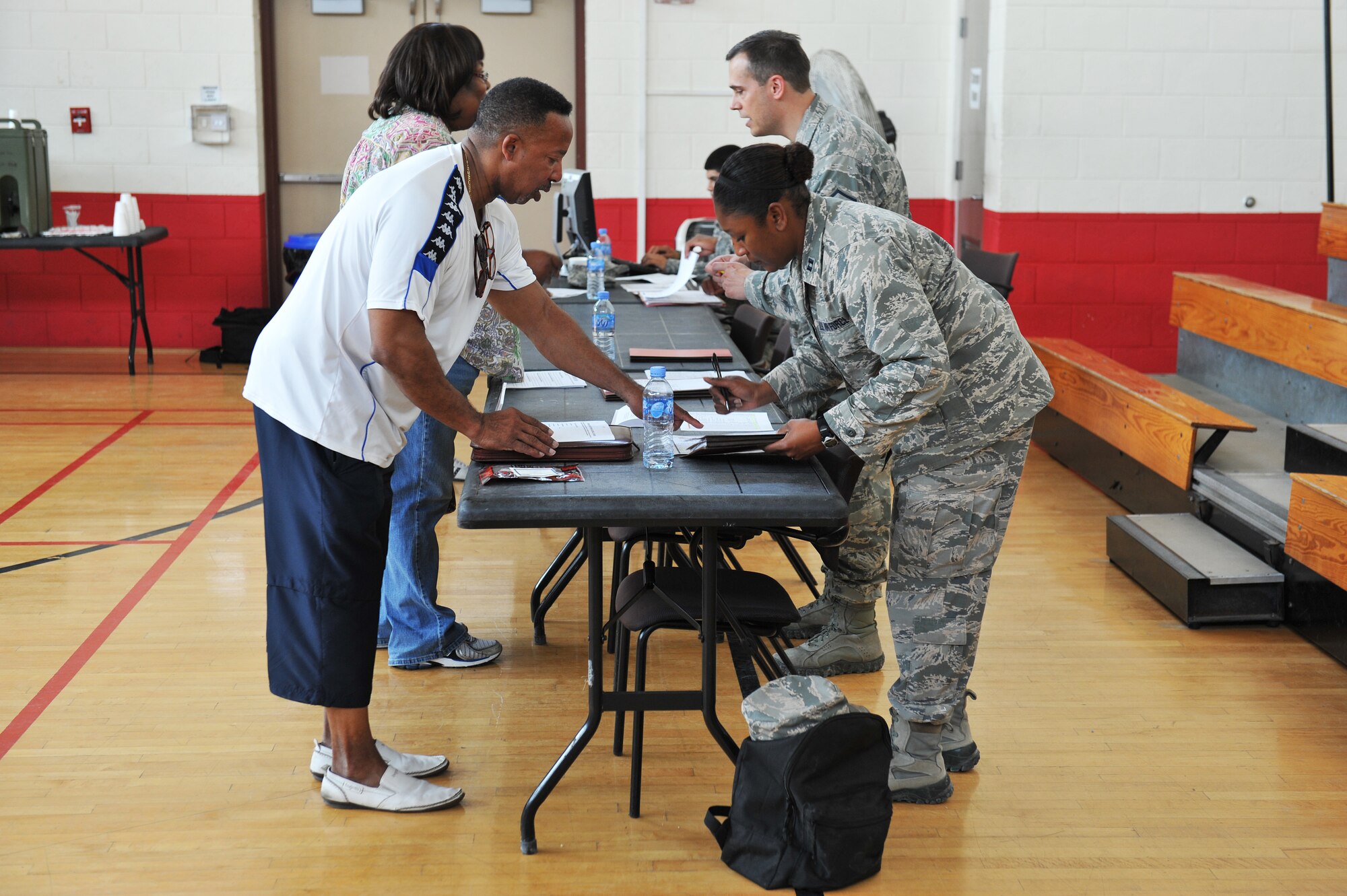 U.S. military dependents and command sponsored civilian’s process through workstations during a noncombatant evacuation operations exercise at an undisclosed location in Southwest Asia, Nov. 16, 2013. The exercise allowed noncombatants and military members from the Air Force and Army to rehearse evacuation procedures in the event of an emergency. (U.S. Air Force photo/Master Sgt. David Miller)