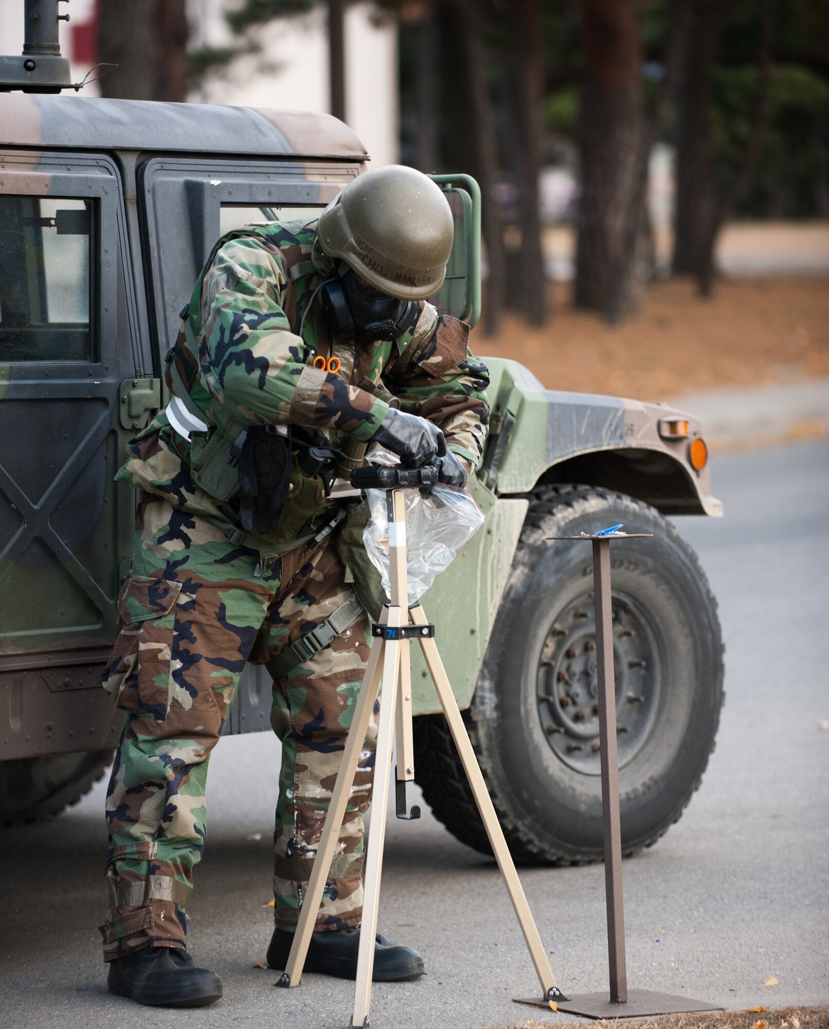 Senior Airman Carlos Marreroestrada, 8th Communications Squadron, disposes of a simulated contaminated liquid detection point after a hostile attack at Kunsan Air Base, Republic of Korea, Nov. 20, 2013. Kunsan continued exercise Beverly Bulldog 14-01 with more simulated hostile actions such as missile, mortar and ground attacks. The base tested its ability to survive and continue its primary missions under simulated hostile field conditions. The Wolf Pack, along with other 7th Air Force units, continued performing its operational and tactical wartime missions during the peninsula-wide exercise. (U.S. Air Force photo by Senior Airman Armando A. Schwier-Morales)
