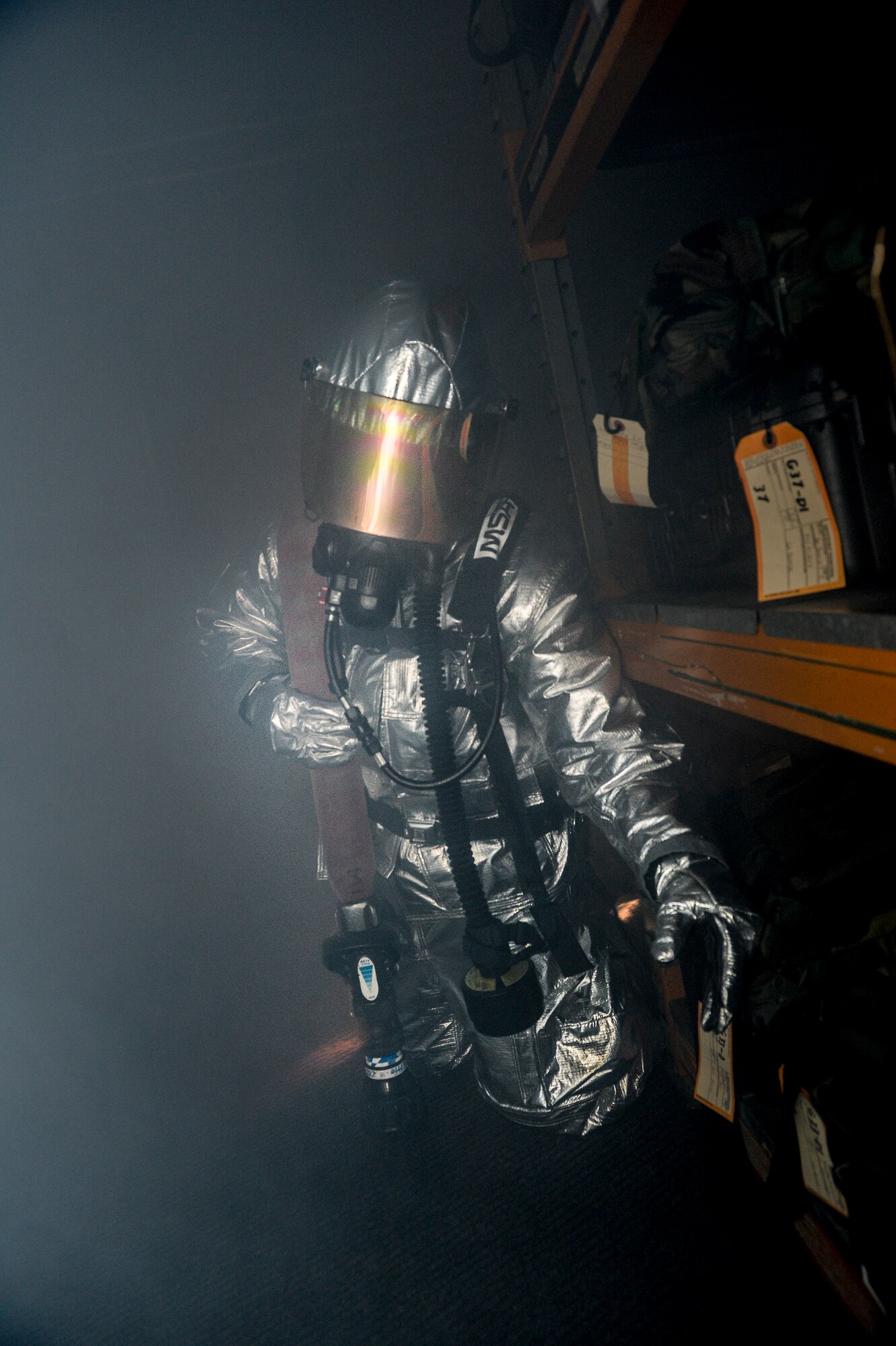 Airman 1st Class Jordan Kubenik, 48th Civil Engineer Squadron firefighter, feels his way through smoke in a simulated fire during a Phase II exercise at Royal Air Force Lakenheath, England, Nov. 20, 2013. Liberty Airmen participated in a series of simulated scenarios to test their readiness. (U.S. Air Force photo by Airman 1st Class Nigel Sandridge/Released)