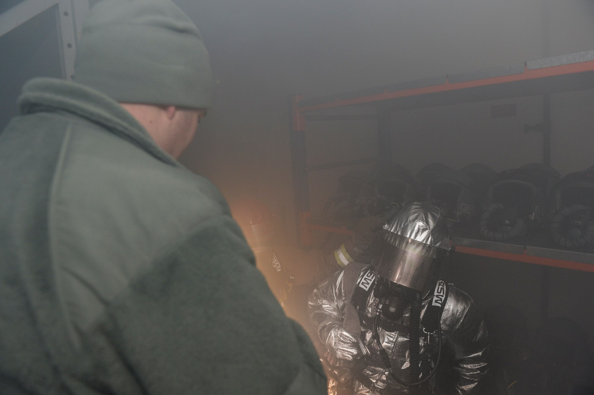 Airman 1st Class Jordan Kubenik, 48th Civil Engineer Squadron firefighter, receives instructions on a mortar bombing scenario during a Phase II exercise at Royal Air Force Lakenheath, England, Nov. 20, 2013. Liberty Airmen participated in a series of simulated scenarios to test their readiness. (U.S. Air Force photo by Airman 1st Class Nigel Sandridge/Released)