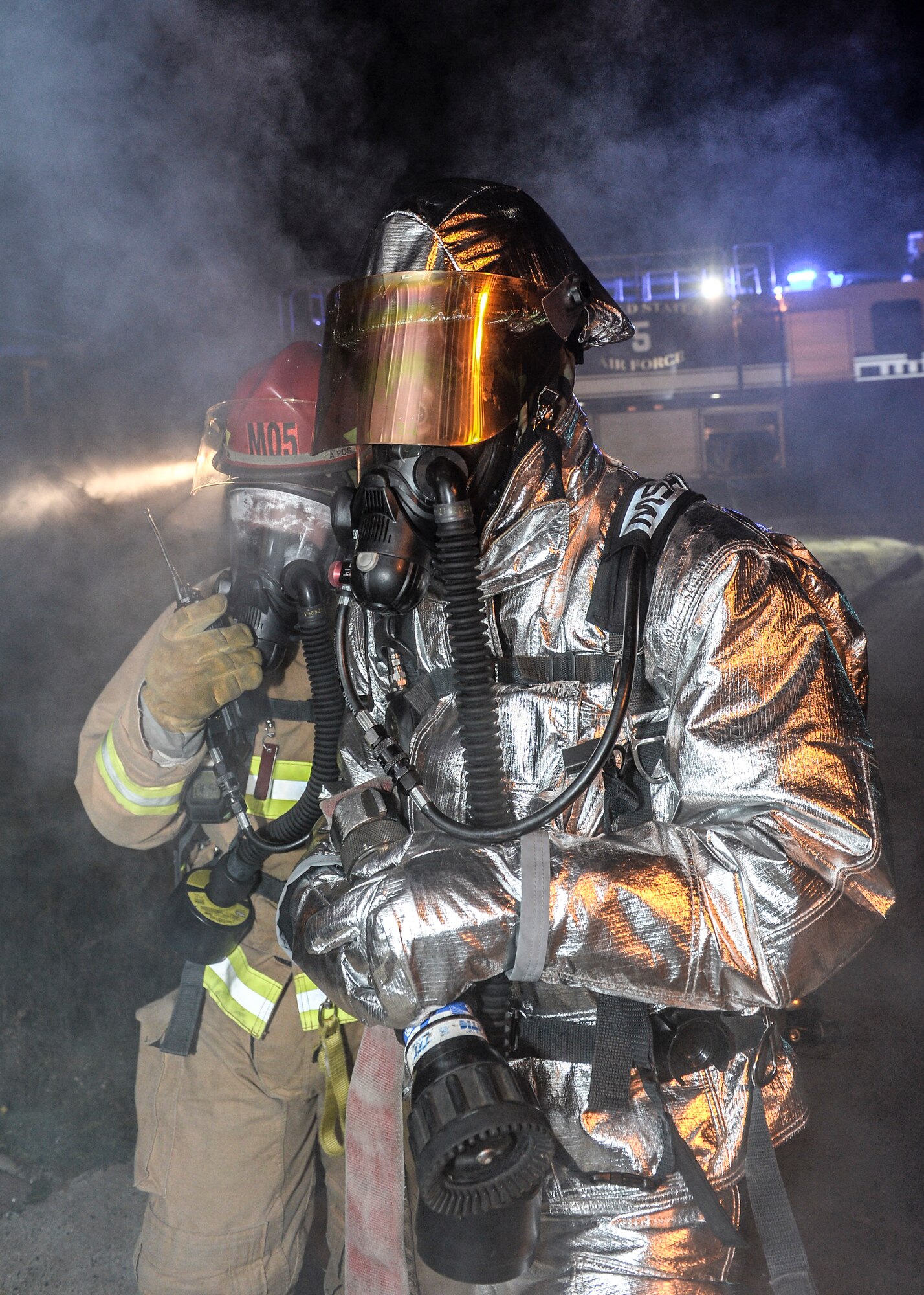 Airman 1st Class Jordan Kubenik and Staff Sgt. Tyler McLain, 48th Civil Engineer Squadron firefighters, get instructions on how to enter a building after a simulated mortar bombing during a Phase II exercise at Royal Air Force Lakenheath, England, Nov. 20, 2013. Liberty Airmen participated in a series of simulated scenarios to test their readiness. (U.S. Air Force photo by Airman 1st Class Nigel Sandridge/Released)