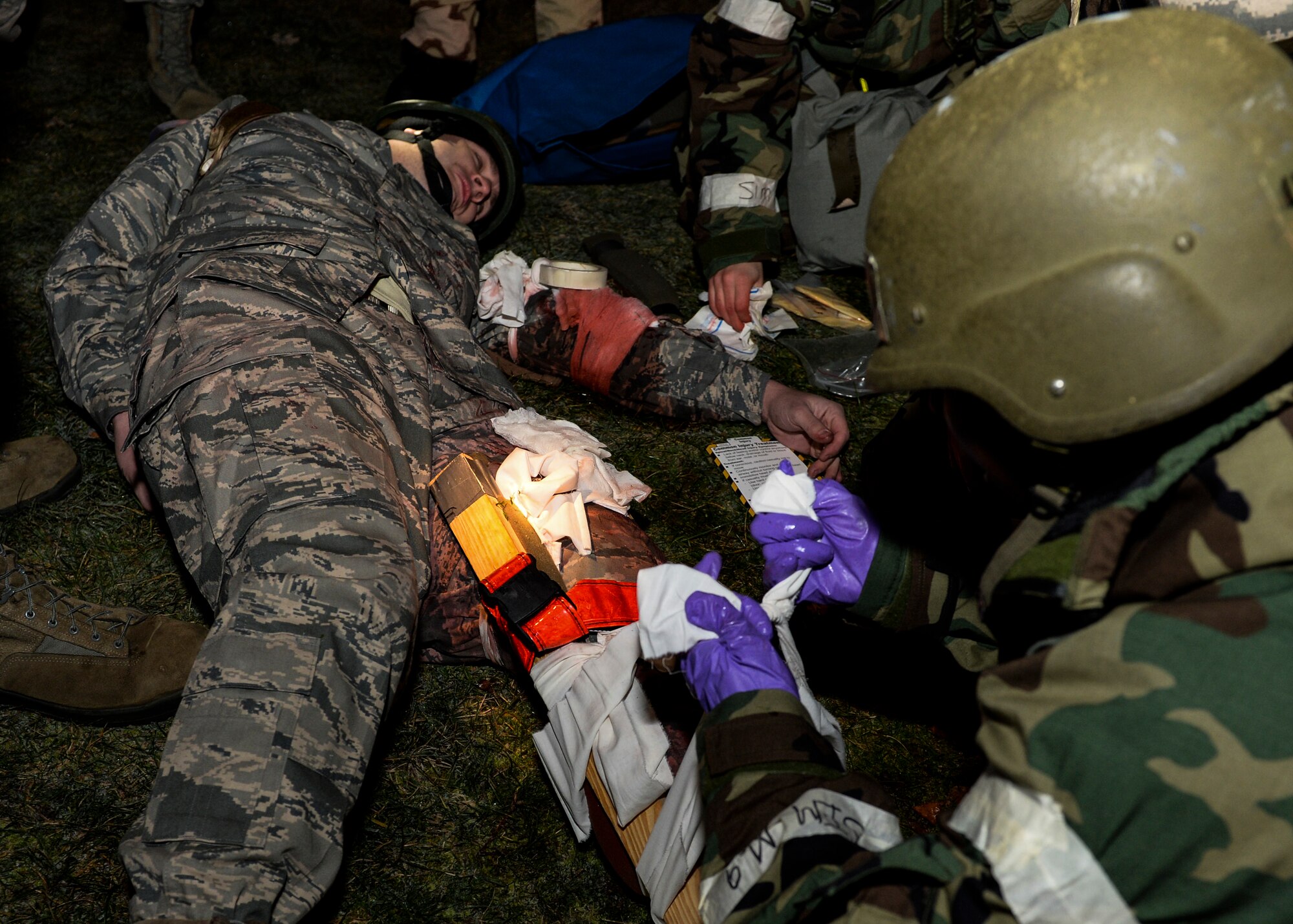 Airmen of the 48th Operations Support Squadron perform self-aid buddy care during a Phase II exercise at Royal Air Force Lakenheath, England, Nov. 20, 2013. Liberty Airmen participated in a series of simulated scenarios to test their readiness. (U.S. Air Force photo by Airman 1st Class Nigel Sandridge/Released)