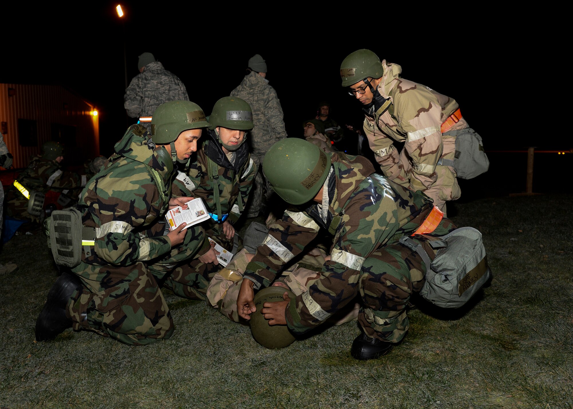 Airmen of the 48th Operations Support Squadron perform self-aid buddy care during a Phase II exercise at Royal Air Force Lakenheath, England, Nov. 20, 2013. Liberty Airmen participated in a series of simulated scenarios to test their readiness. (U.S. Air Force photo by Airman 1st Class Nigel Sandridge/Released)