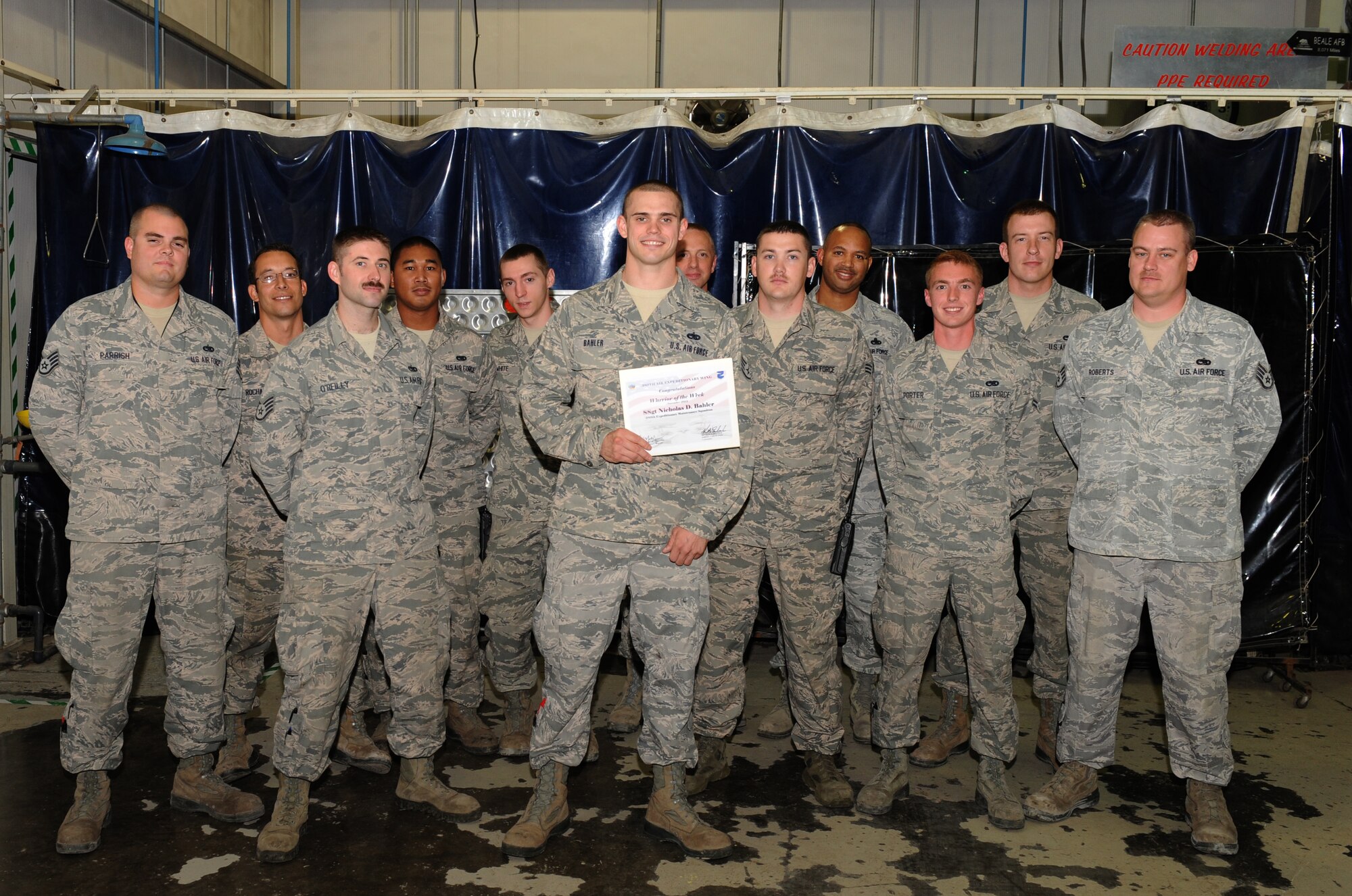 Warrior of the Week, Staff Sgt. Nicholas Bahler, sorrounded by his Fabrications Flight team.