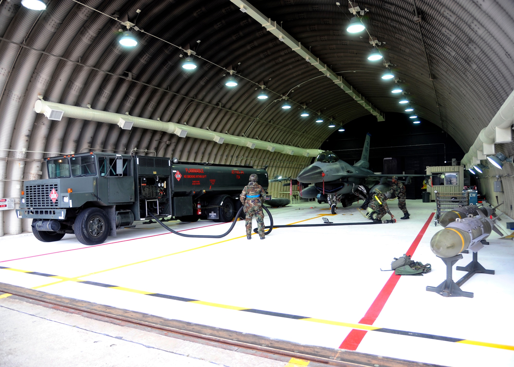 Airmen from the 8th Aircraft Maintenance Squadron, refuel an F-16 during exercise Beverly Bulldog 14-01 at Kunsan Air Base, Republic of Korea, Nov. 20, 2013. Exercise Beverly Bulldog 14-01 demonstrates and enhances the readiness of 7th Air Force to defend and sustain the capabilities which strengthen the ROK-U.S. Alliance. (U.S. Air Force photo by Staff Sgt. Jessica Haas/Released)