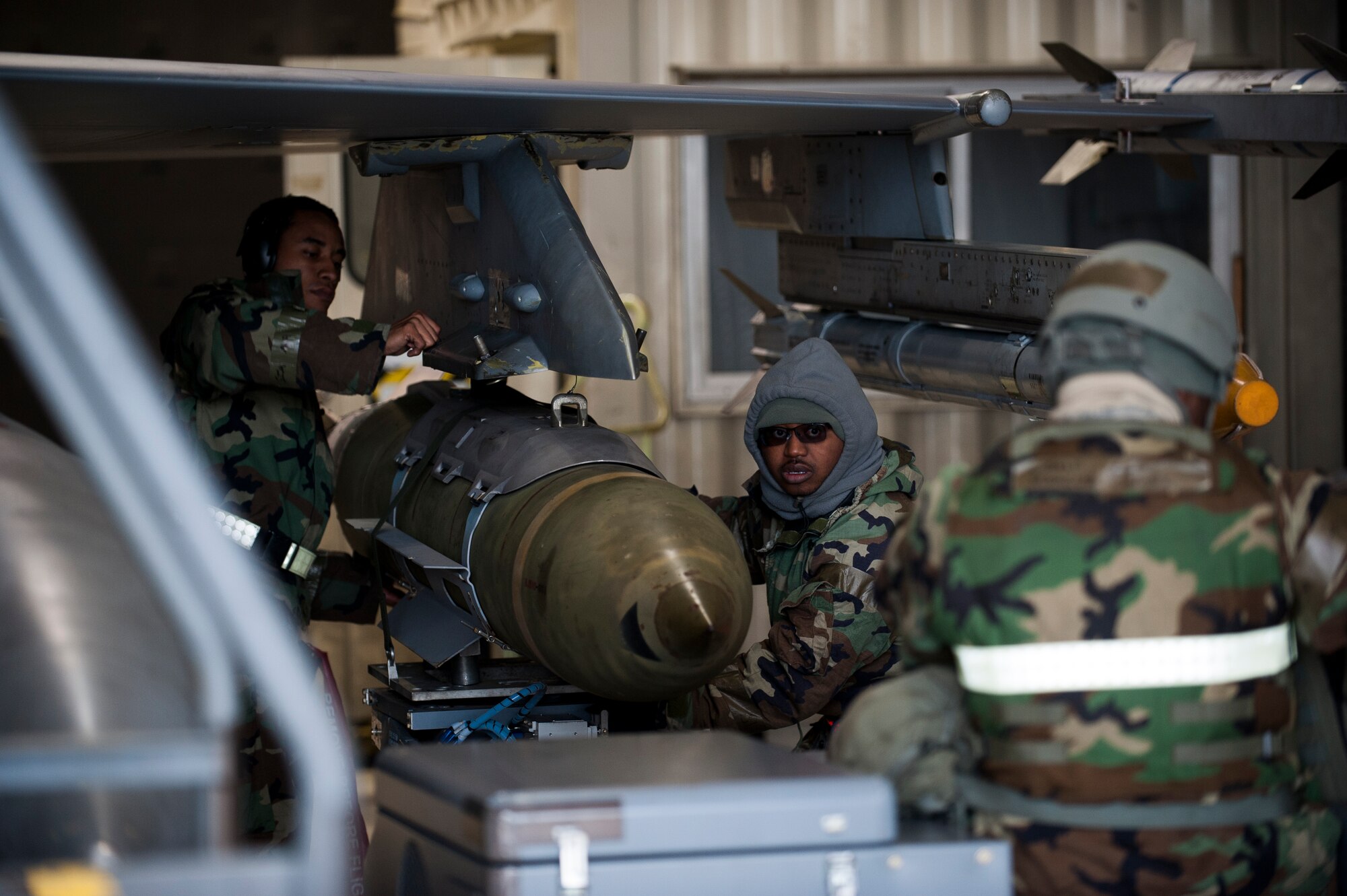 Left to right: Staff Sgts. Craig Gibbs, Jessie Barnett and Marcus Knight, 8th Aircraft Maintenance Squadron, re-arm an F-16 during exercise Beverly Bulldog 14-01 at Kunsan Air Base, Republic of Korea, Nov. 20, 2013. Exercise Beverly Bulldog 14-01 demonstrates and enhances the readiness of 7th Air Force to defend and sustain the capabilities which strengthen the ROK-U.S. Alliance. (U.S. Air Force photo by Senior Airman Clayton Lenhardt/Released)