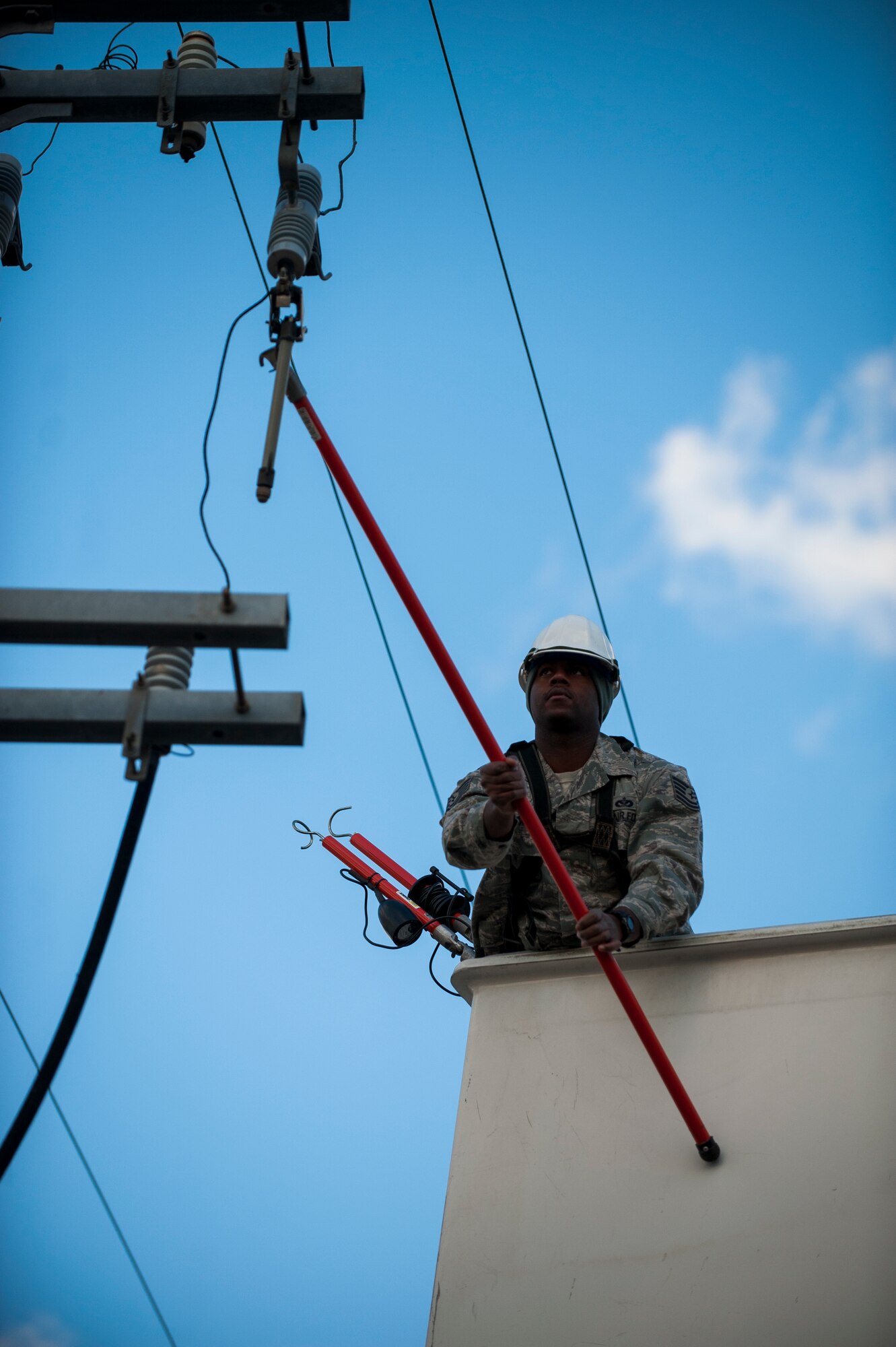 Tech. Sgt. Donald Ingram, 8th Civil Engineer Squadron, works to restore power to the main gate at Kunsan Air Base, Republic of Korea, Nov. 20, 2013. A mechanical failure disrupted gate functions for a short period of time before the 8th CES restored power. (U.S. Air Force Photo by Senior Airman Clayton Lenhardt/Released)
