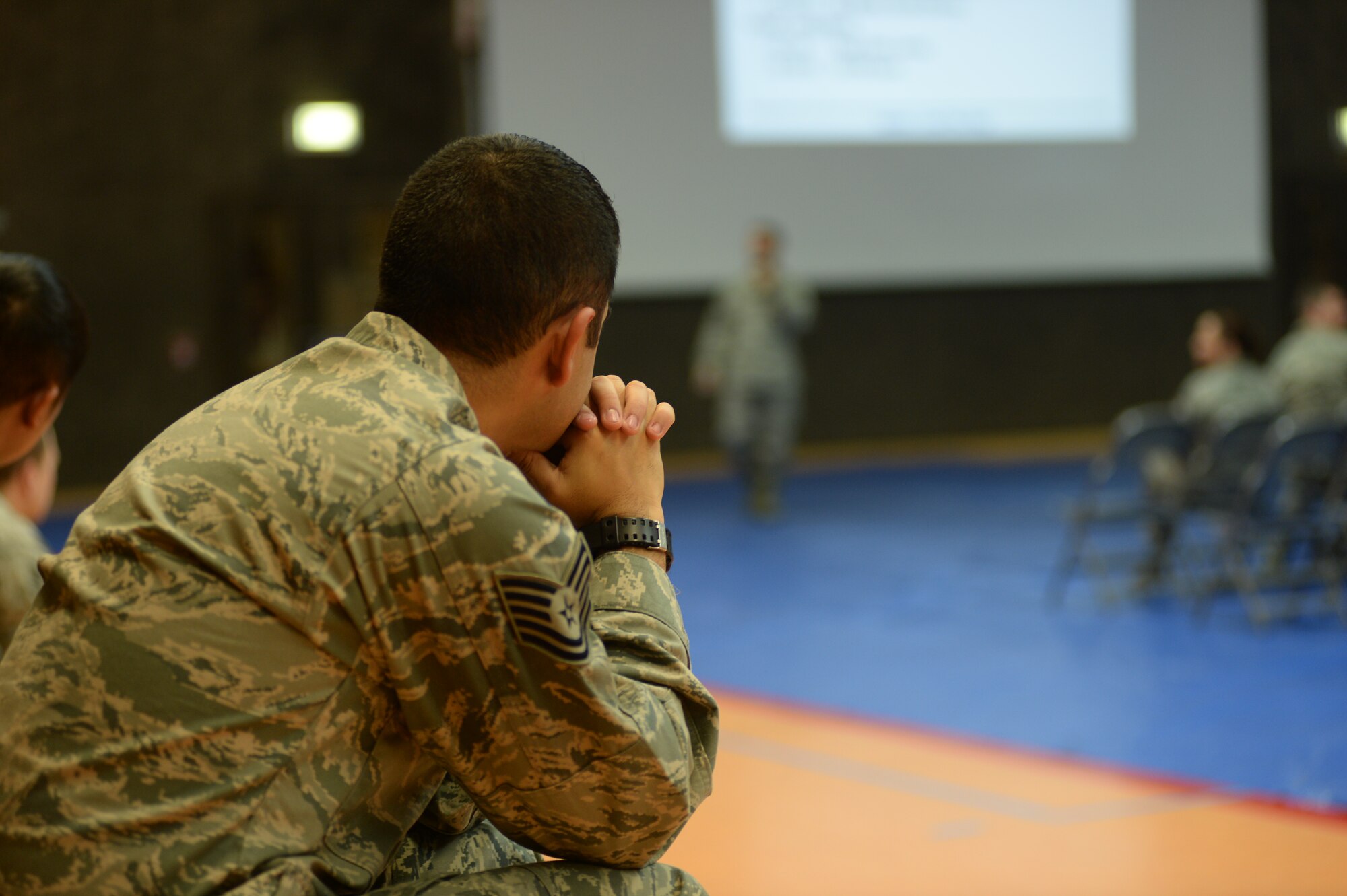 SPANGDAHLEM AIR BASE, Germany --- A Spangdahlem technical sergeant listens as Col. David Julazadeh, 52nd Fighter Wing commander, makes a point during a commander’s call at the Skelton Memorial Fitness Center Nov. 18, 2013. The commander spoke with Airmen on topics ranging from recent inspections to wearing reflective belts. (U.S. Air Force photo by Staff Sgt. Joe W. McFadden / Released)