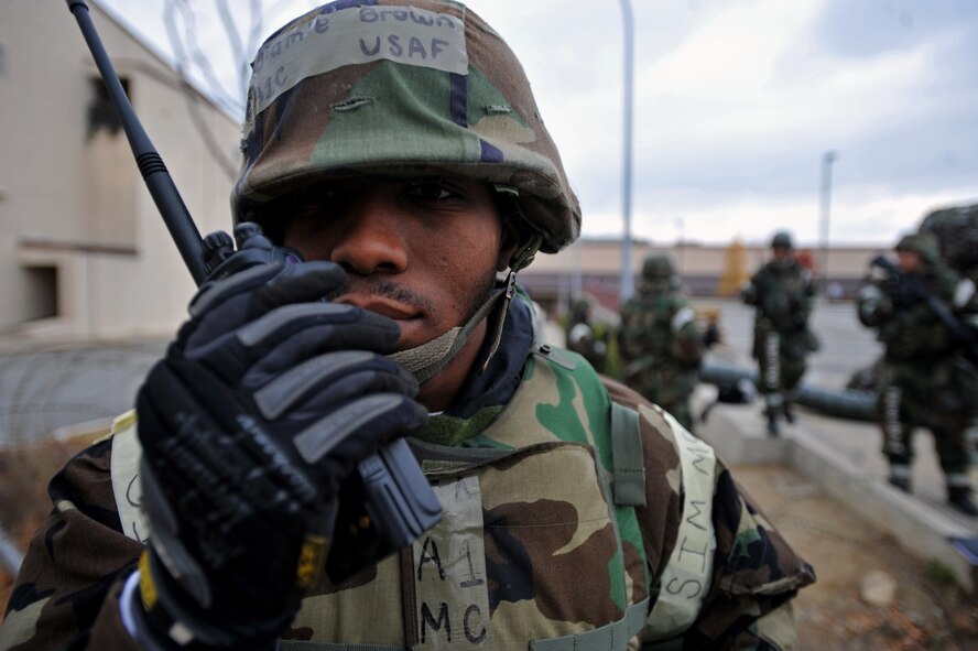 Airman 1st Class Jamie Brown radios the 51st Communications Squadron Unit Control Center after an unauthorized exercise participant attempted to breach an entry control point at Osan Air Base, Republic of Korea, Nov. 20, 2013. Brown is a member of the squadron’s Installation Arming and Response Team. (U.S. Air Force photo/Senior Airman Siuta B. Ika)