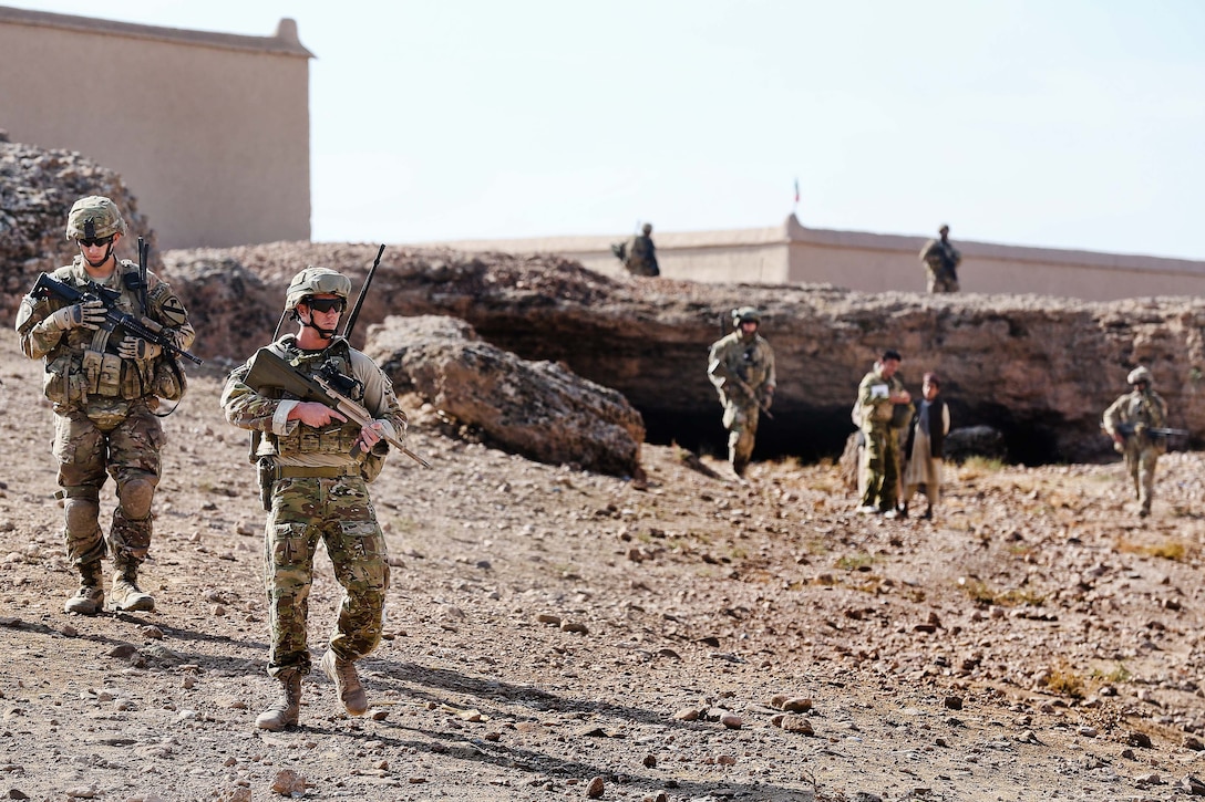 U.S. Army Lt. Jordan T. Dea, left, and Royal Australian air force Sgt. Chris Hey participate in a theater assistance force handover patrol near Multinational Base Tarin Kowt in Uruzgan province, Afghanistan, Nov. 10, 2013. Dea is assigned to 1st Battalion, 8th Cavalry Regiment.