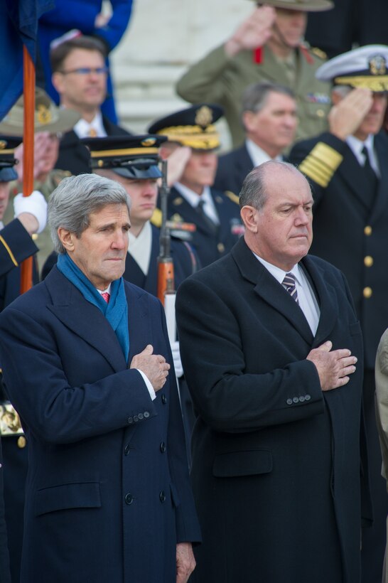 U.S. Secretary of State John Kerry, left, and Australian Defense Minister David Johnston, right, render honors at the Tomb of the Unknown Soldier in Arlington National Cemetery, Va., Nov. 20, 2013. 