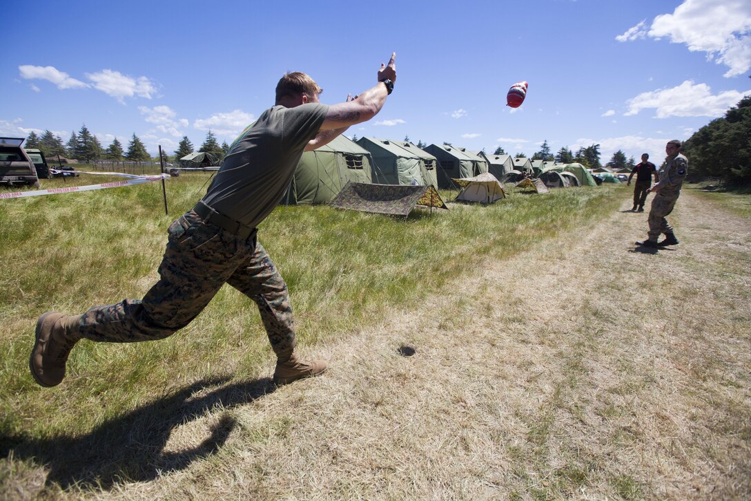 Sgt. Greg Wubben, a civil affairs non-commissioned officer with 1st Civil Affairs Group, I Marine Expeditionary Force, from Ridgefield, Wash., learns how to throw a rugby ball for the first time in the field during exercise Southern Katipo 2013 aboard Timaru, New Zealand, Nov. 16. SK13 allows our service members to collaborate with partner countries to achieve mutual security goals, address shared concerns and continue to enhance our interoperability. 