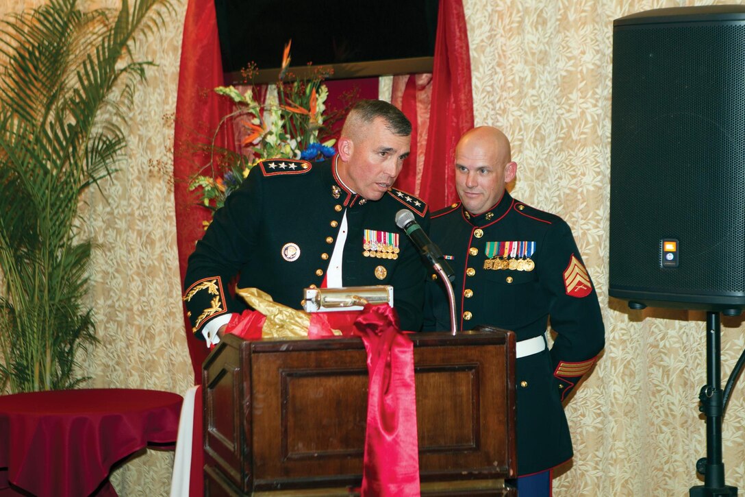 Lt. Gen. John Wissler, left, prepares to present a ceremonial gift to the guest of honor during the III Marine Expeditionary Force Marine Corps birthday ball Nov. 8 at the Butler Officers’ Club on Camp Foster. At this year's III MEF ball, Wissler invited Sgt. Michael D. Mansholt to be the guest of honor because he believes Mansholt epitomizes what it is to be a Marine noncommissioned officer. Wissler is the commanding general of III MEF, and Mansholt is a military policeman with 3rd Law Enforcement Battalion, III MEF Headquarters Group, III MEF. 