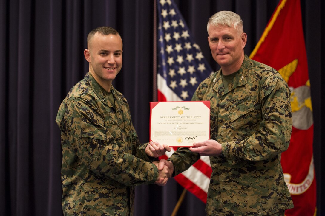 Col. Christian G. Cabaniss, Marine Barracks Washington D.C. commanding officer, presented a Navy Commendation Medal to Capt. Nicholas Schroback, former Company B commander, during a change of command ceremony at the Barracks Nov. 18.