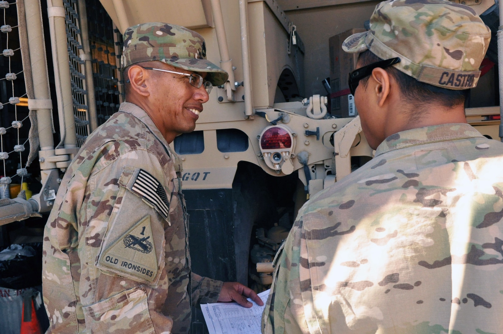 Sgt. 1st Class Patrick J. Flores Sr., left, the platoon sergeant for Echo Company, 1st Battalion, 249th Infantry Regiment, Task Force Guam, discusses maintenance issues with his soldiers at Camp Phoenix in Kabul.