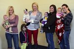 Gynger Hert with son Maverick, Tabatha Medina with daughters Delilah and Emmie, Sarah Willey with daughter Ariea and Stephanie Joy with daughter Ainsley during a National Guard family reunion event in Peoria, Ill., Nov. 16, 2013. These are four of six babies born while their dads were deployed to Afghanistan.