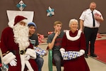 Operation Santa Claus visited Kake Nov. 14, 2013, in the 57th year of the event. Monte Doyle as Santa and Leslie Richards as Mrs. Claus meet with Kake High School students as Salvation Army volunteer Michael Evans stands by.