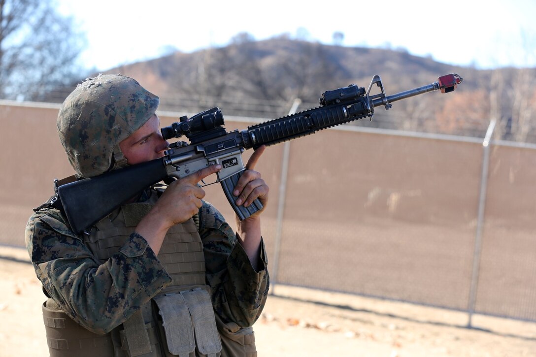 MARINE CORPS BASE CAMP PENDLETON, Calif., -- Lance Cpl. Bryan Olesky, radio operator, Tango Battery, 5th Battalion, 11th Marine Regiment, and a native of Akron, Ohio, spots an enemy role-player at the top of a hill during a training exercise at the Mobile Immersion Trainer here, Nov. 14, 2013. The MIT is similar to the Infantry Immersion Trainer and trains Marines to operate under stressful conditions. Throughout the morning, the battery simulated operating out of a base and posted security while mock insurgents attempted to breach the area and formed riots. The artillerymen later conducted a logistics patrol and recovered a broken vehicle, countered an improvised explosive device and repelled enemy role-players during an ambush. The battery is slated to continue predeployment training before deploying to Afghanistan this winter.