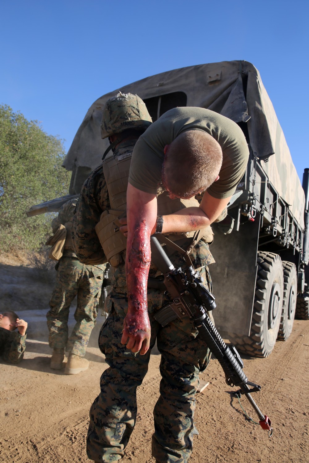 MARINE CORPS BASE CAMP PENDLETON, Calif., -- Corporal Ben Marcear, radio chief, Tango Battery, 5th Battalion, 11th Marine Regiment, and a native of Richland, Wash., carries a simulated casualty to a safety vehicle during a training exercise at the Mobile Immersion Trainer here, Nov. 14, 2013. The MIT is similar to the Infantry Immersion Trainer and trains Marines to operate under stressful conditions. Throughout the morning, the battery simulated operating out of a base and posted security while mock insurgents attempted to breach the area and formed riots. The artillerymen later conducted a logistics patrol and recovered a broken vehicle, countered an improvised explosive device and repelled enemy role-players during an ambush. The battery is slated to continue predeployment training before deploying to Afghanistan this winter.