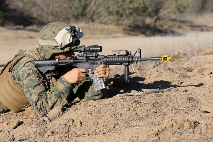 MARINE CORPS BASE CAMP PENDLETON, Calif., -- Sergeant Michael Baldwin, launcher chief, Tango Battery, 5th Battalion, 11th Marine Regiment, and a native of Carrollton, Ohio, engages enemy role-players during a training exercise at the Mobile Immersion Trainer here, Nov. 14, 2013. The MIT is similar to the Infantry Immersion Trainer and trains Marines to operate under stressful conditions. Throughout the morning, the battery simulated operating out of a base and posted security while mock insurgents attempted to breach the area and formed riots. The artillerymen later conducted a logistics patrol and recovered a broken vehicle, countered an improvised explosive device and repelled enemy role-players during an ambush.